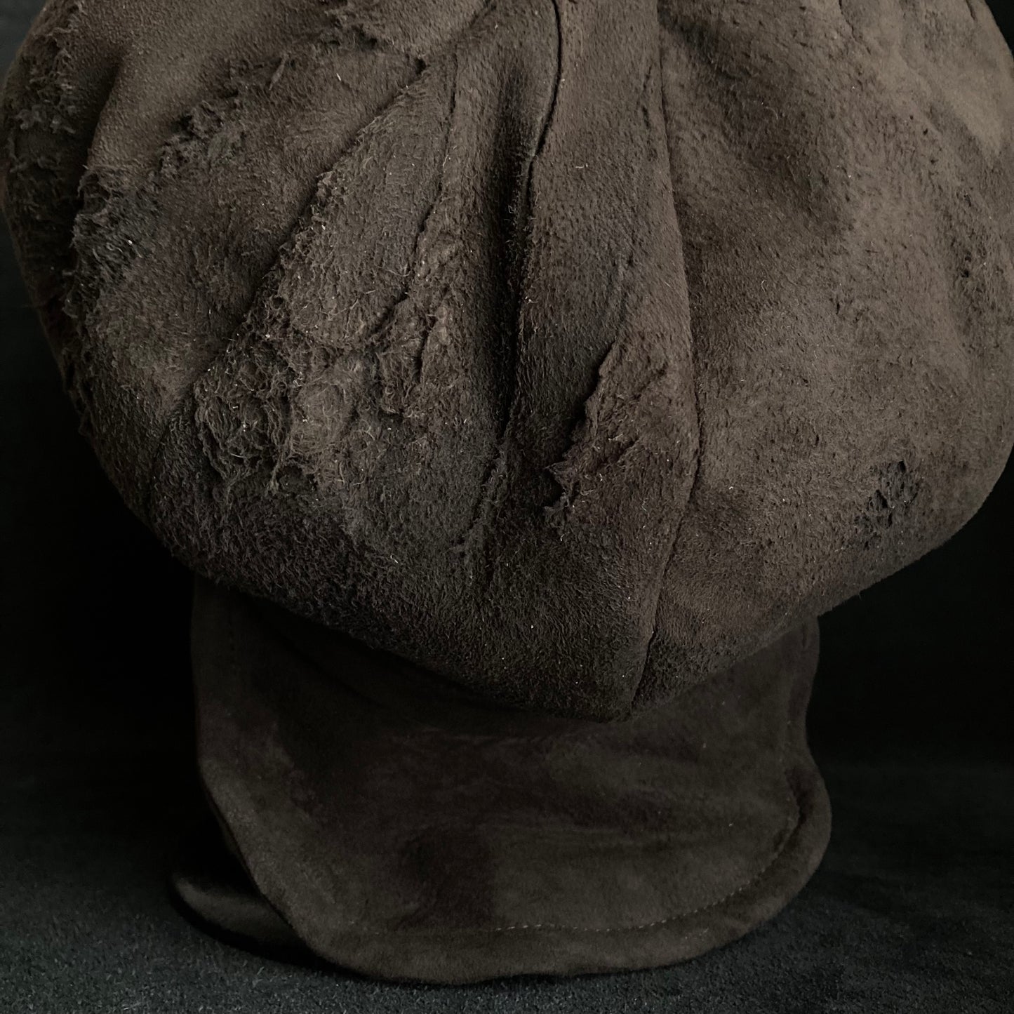 Worn out dark brown leather casquette
