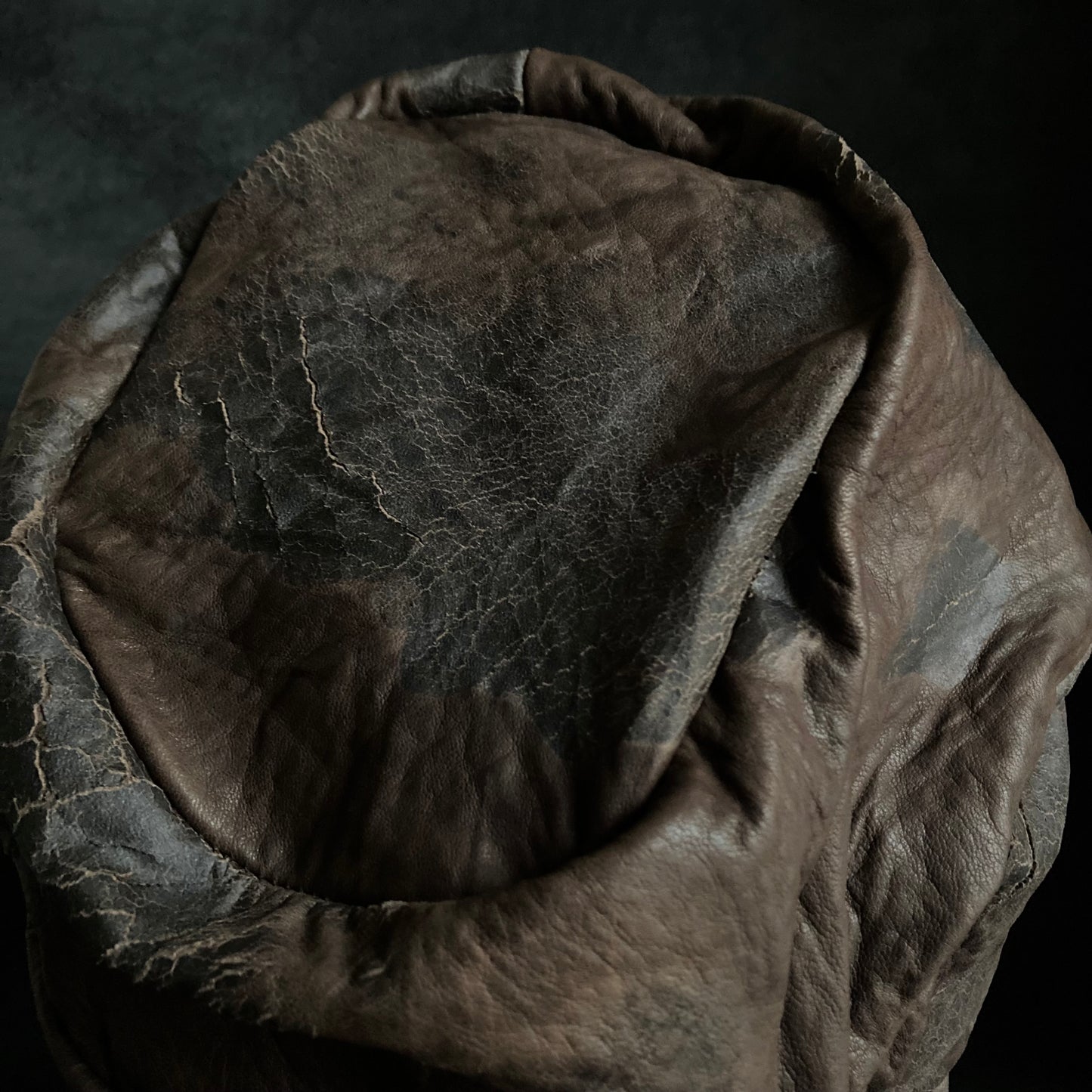 Cracked dark brown leather turn cap