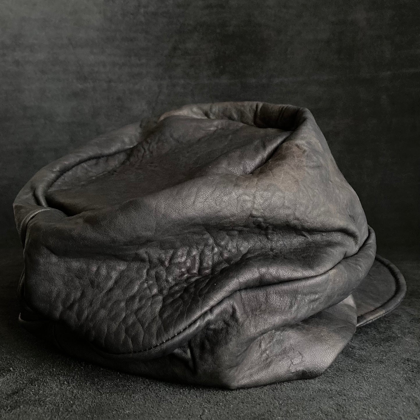 Wiggly black leather turn cap