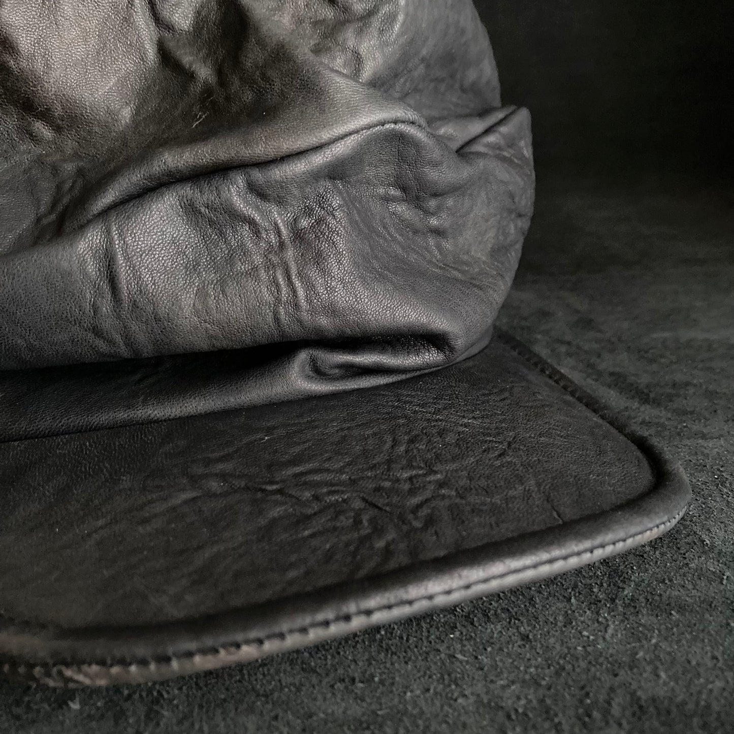 Wiggly black leather turn cap