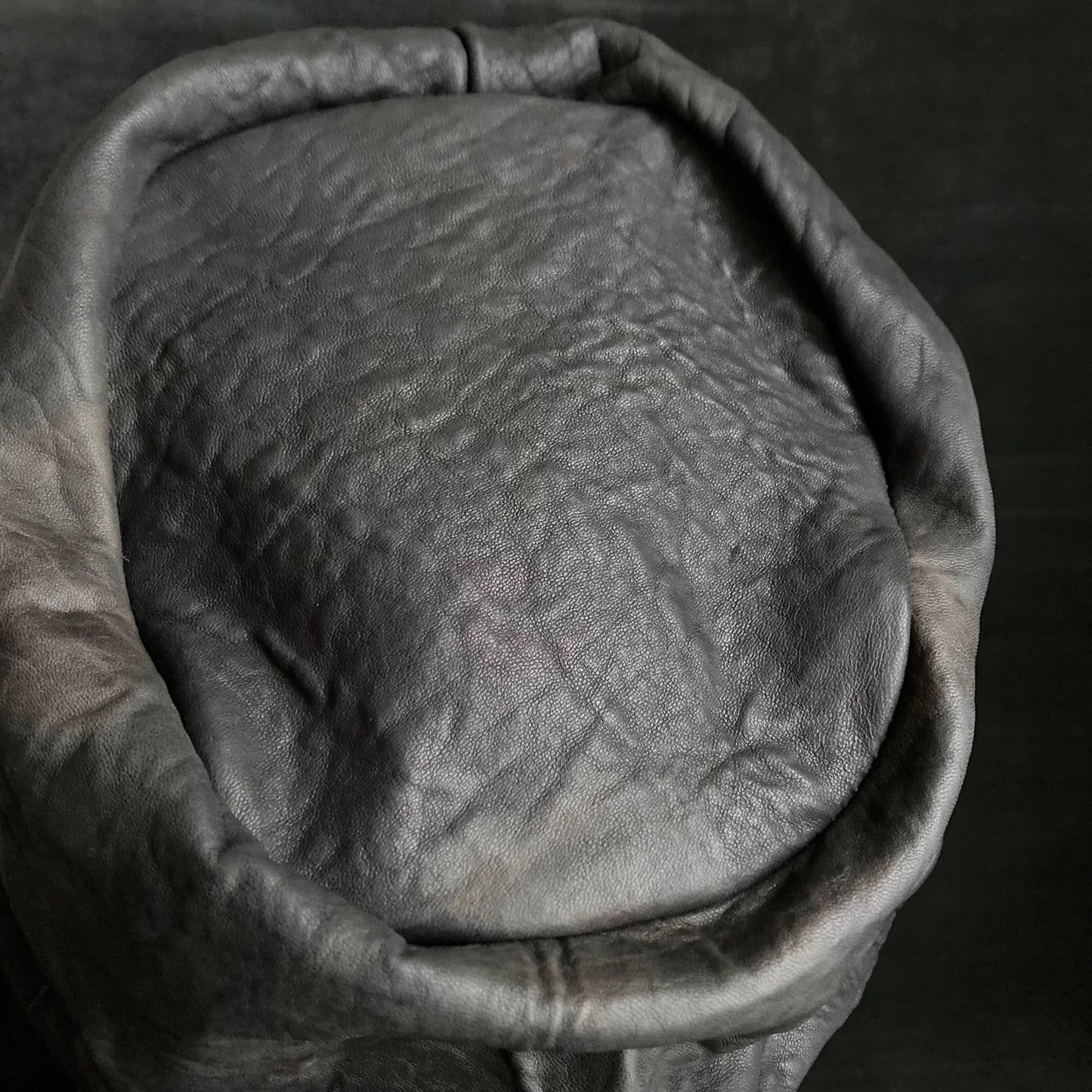 Wiggly black leather turn cap