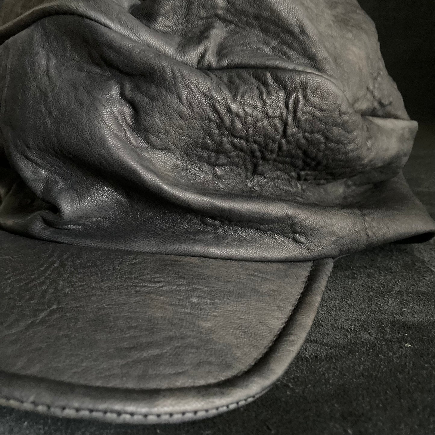 Wiggly black leather turn cap