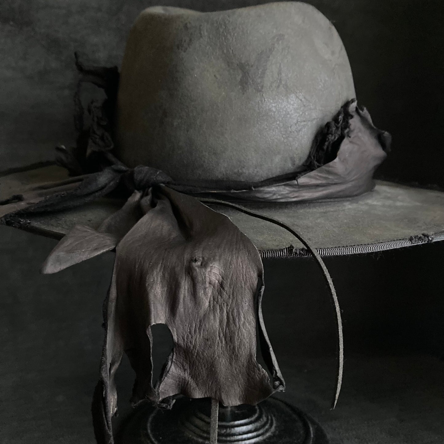 Charcoal leather erodes fedora hat