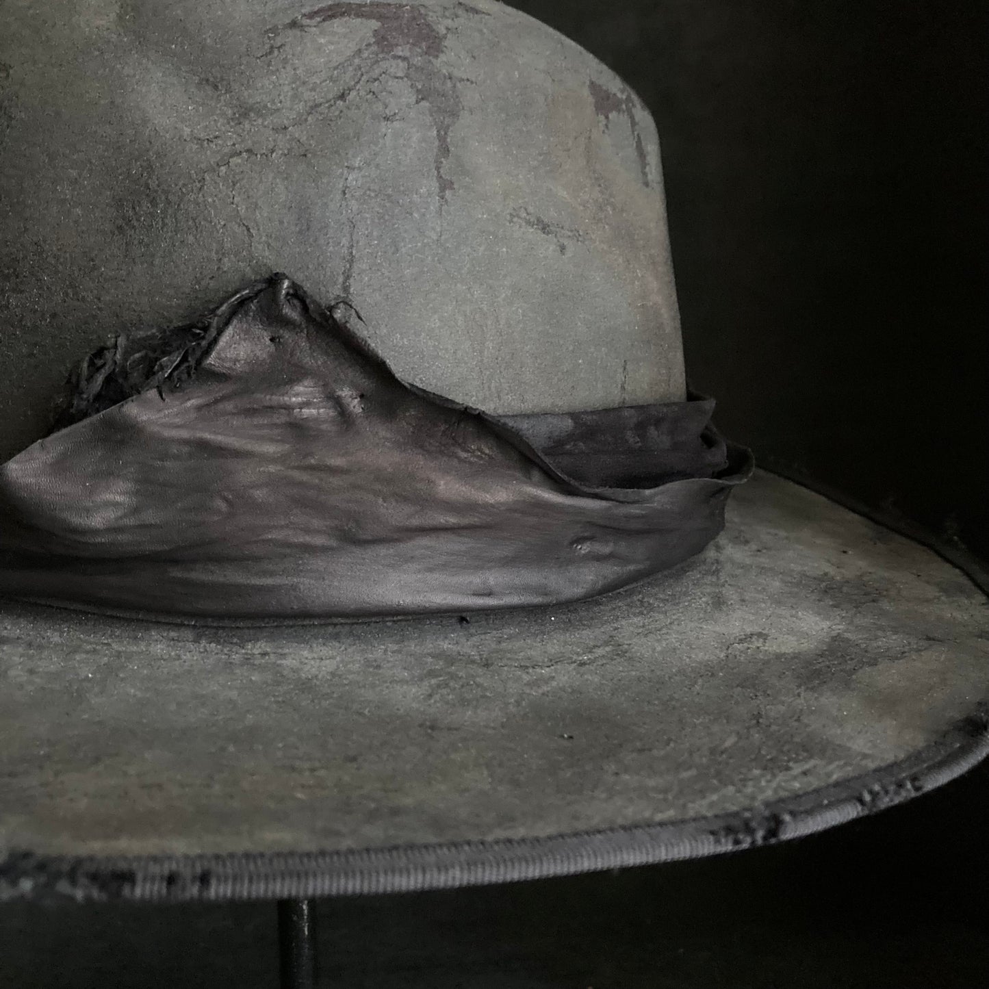 Charcoal leather erodes fedora hat