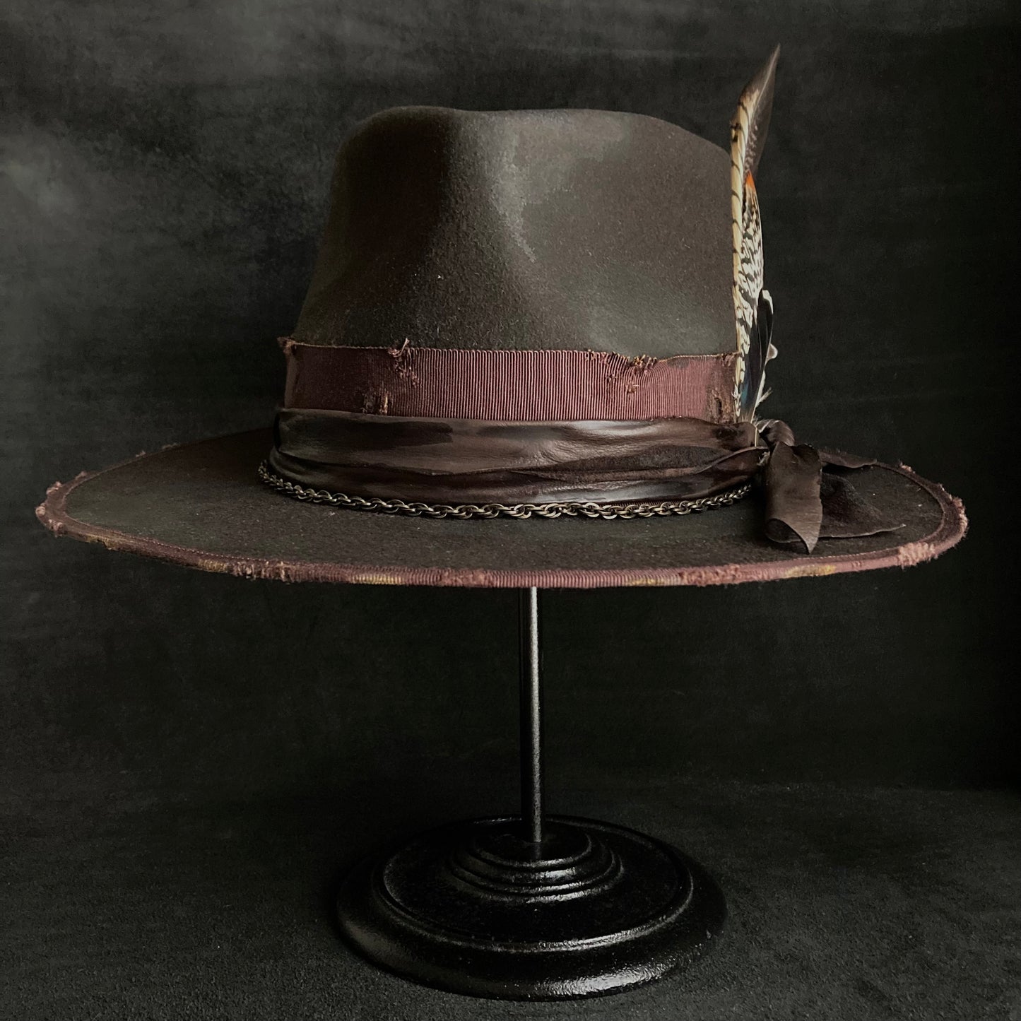 Dark brown flies away burned fedora hat