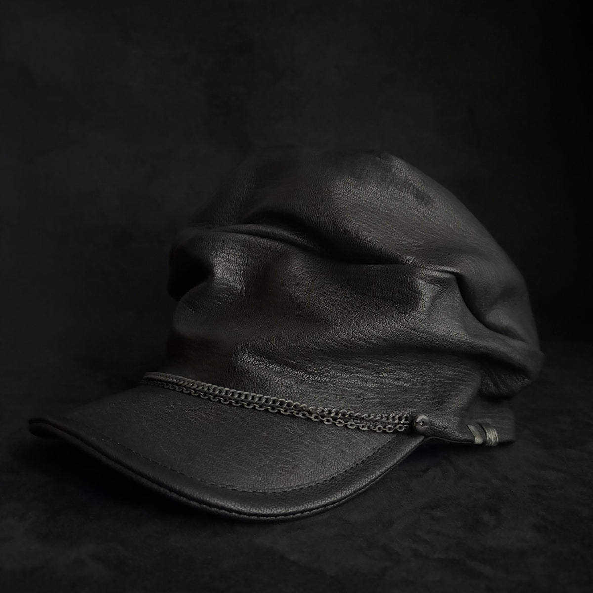Grit black leather turn cap