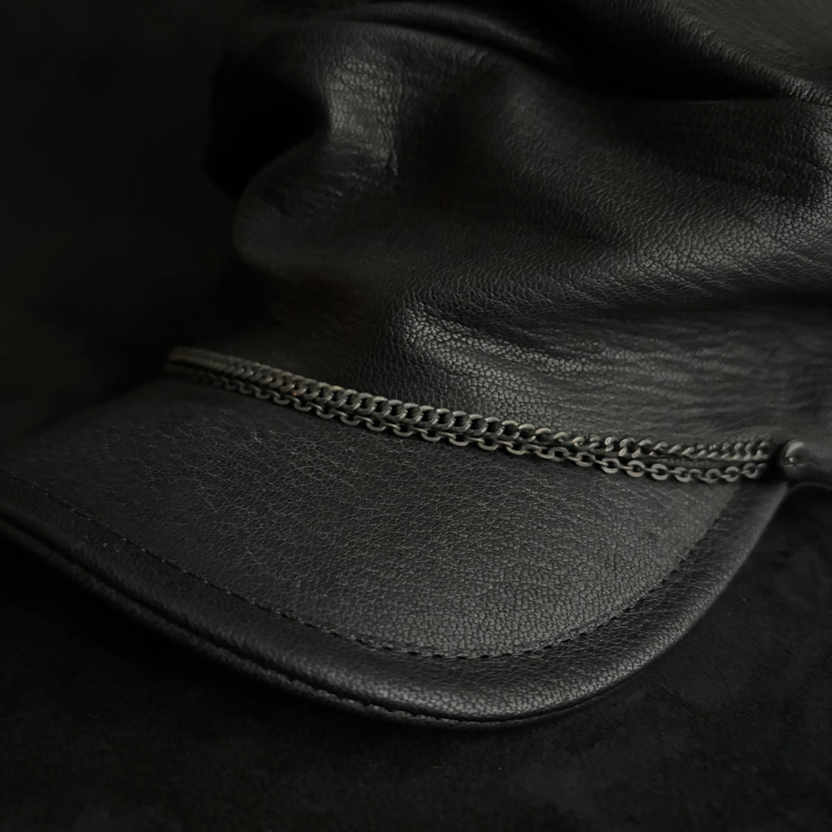 Grit black leather turn cap