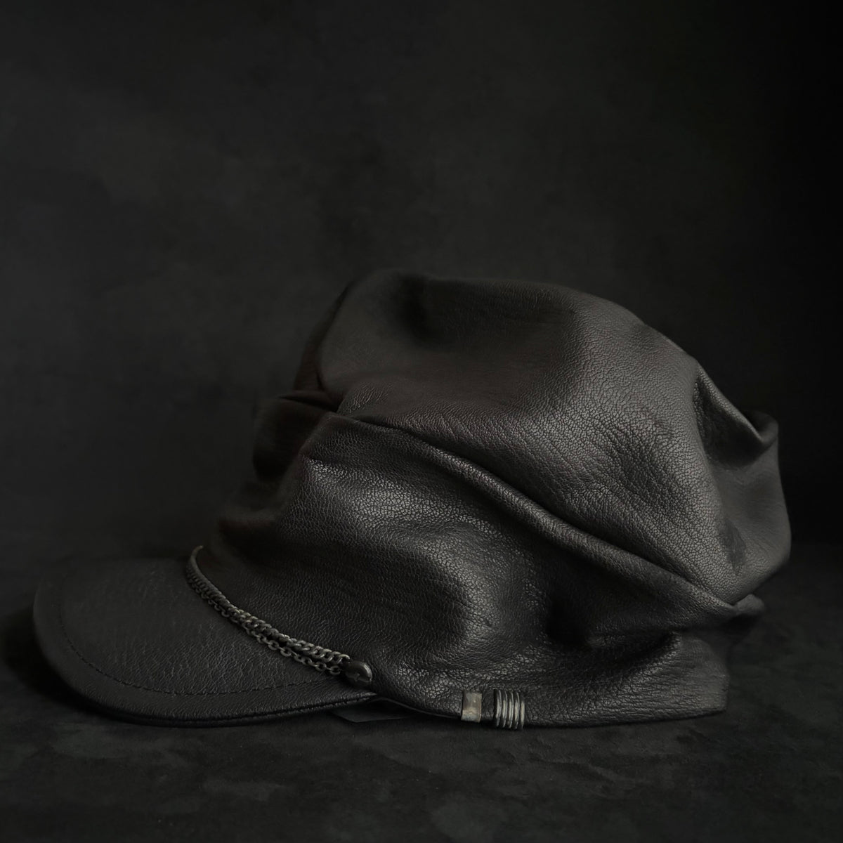 Grit black leather turn cap