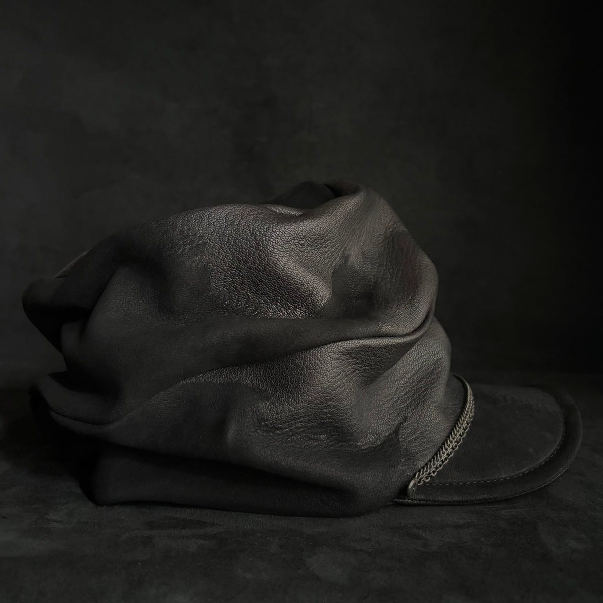 Grit black leather turn cap
