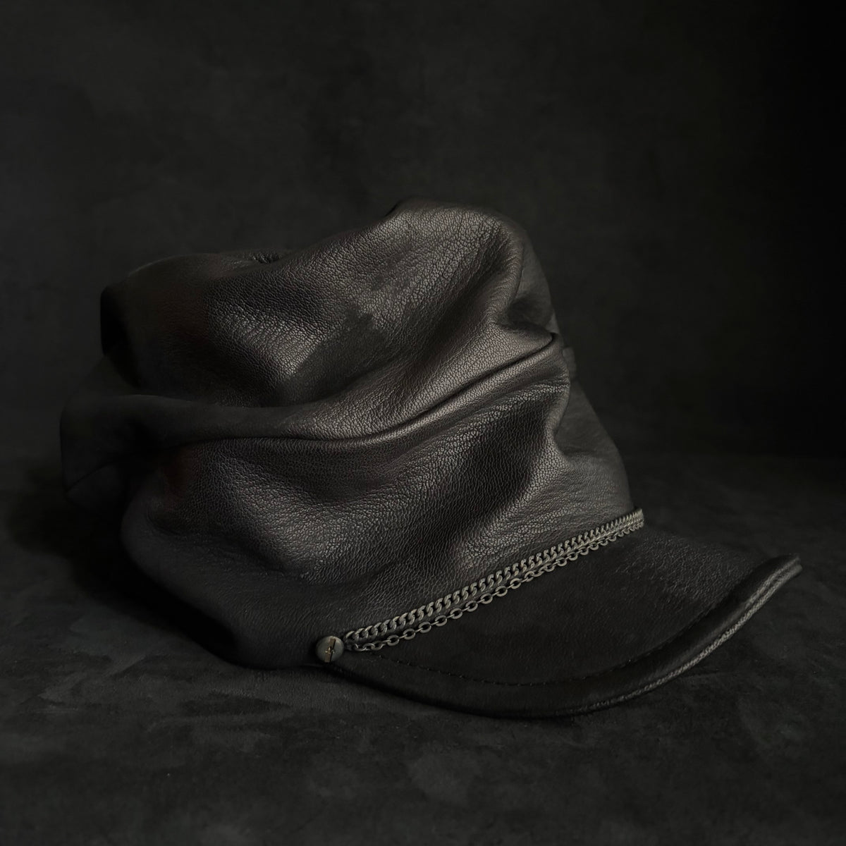 Grit black leather turn cap