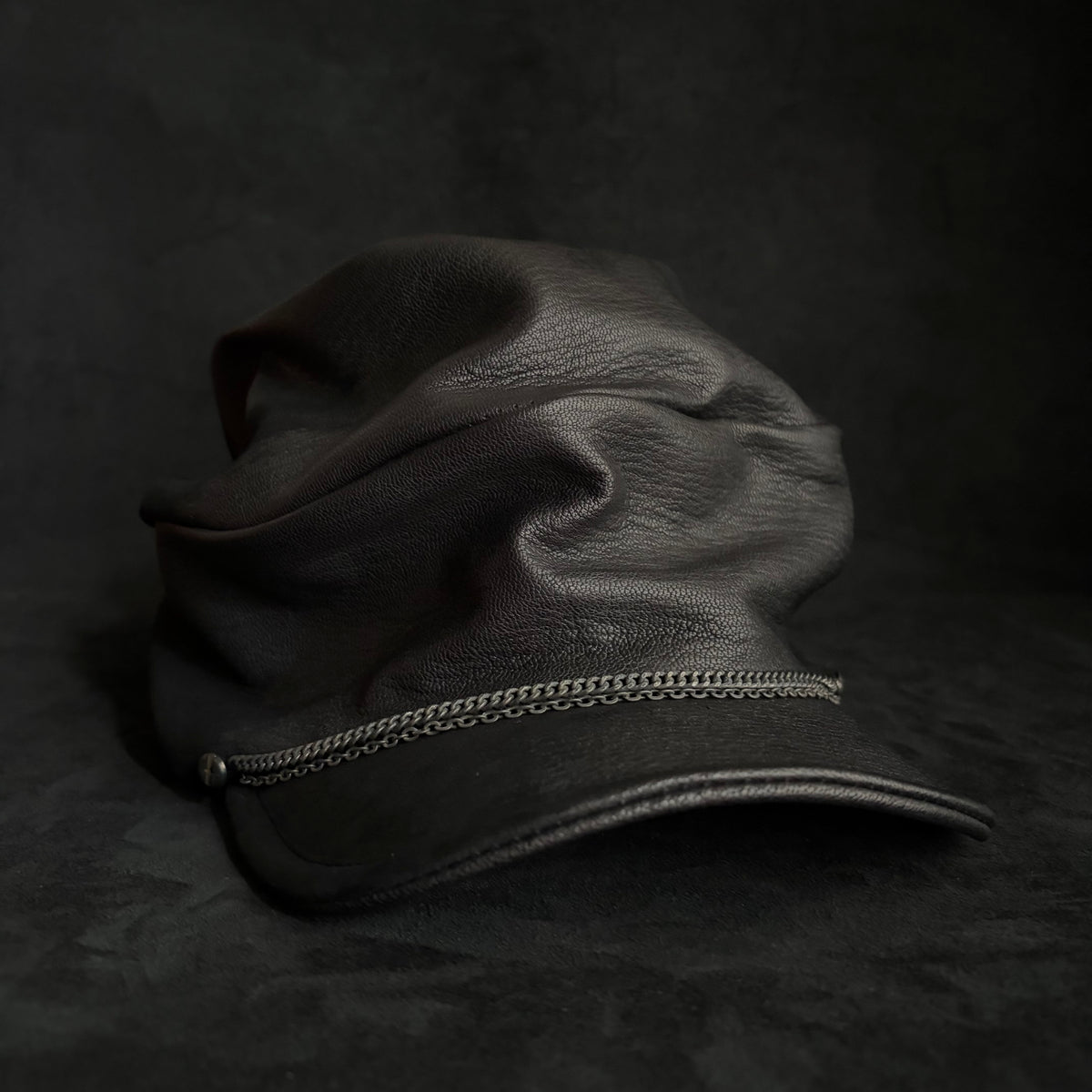 Grit black leather turn cap
