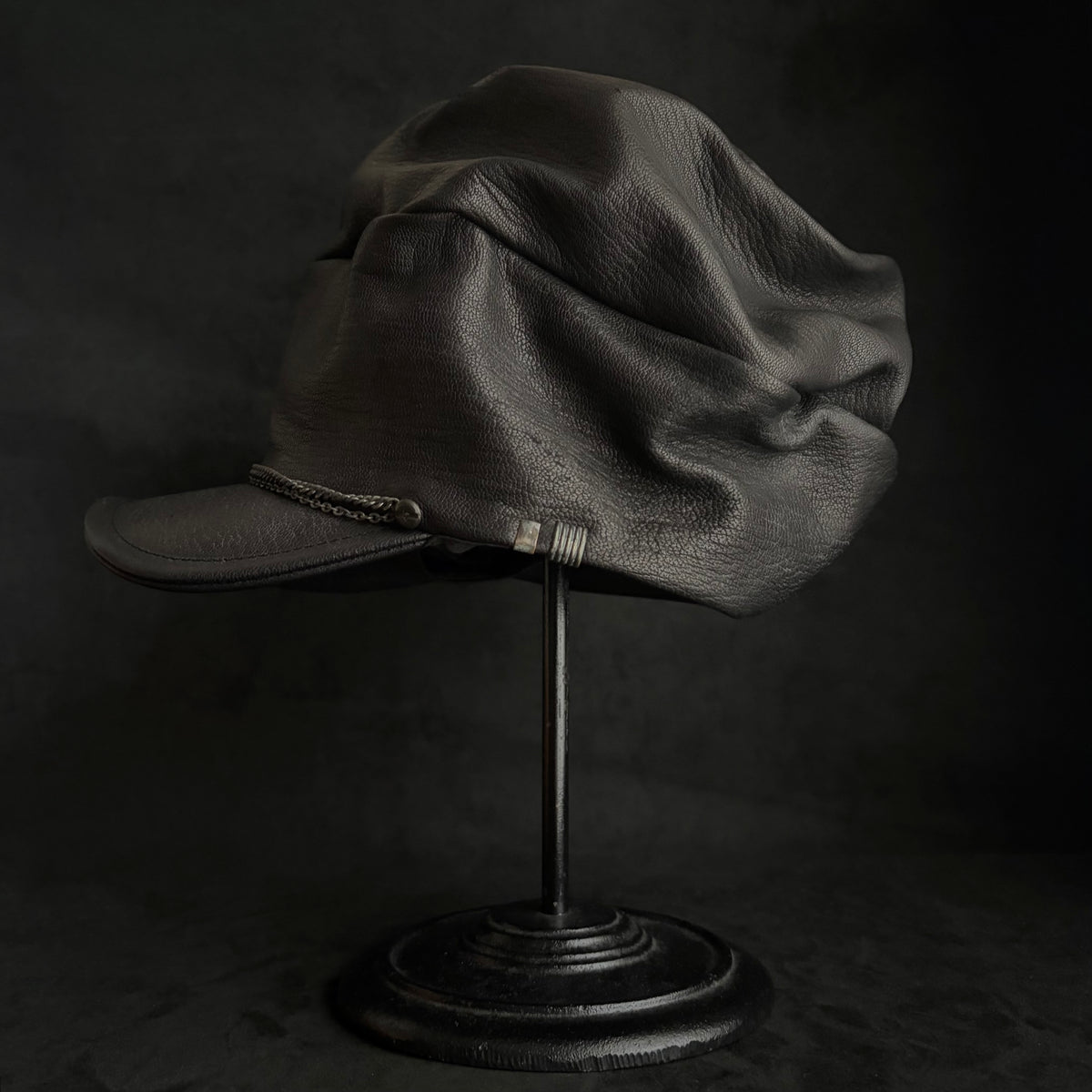 Grit black leather turn cap