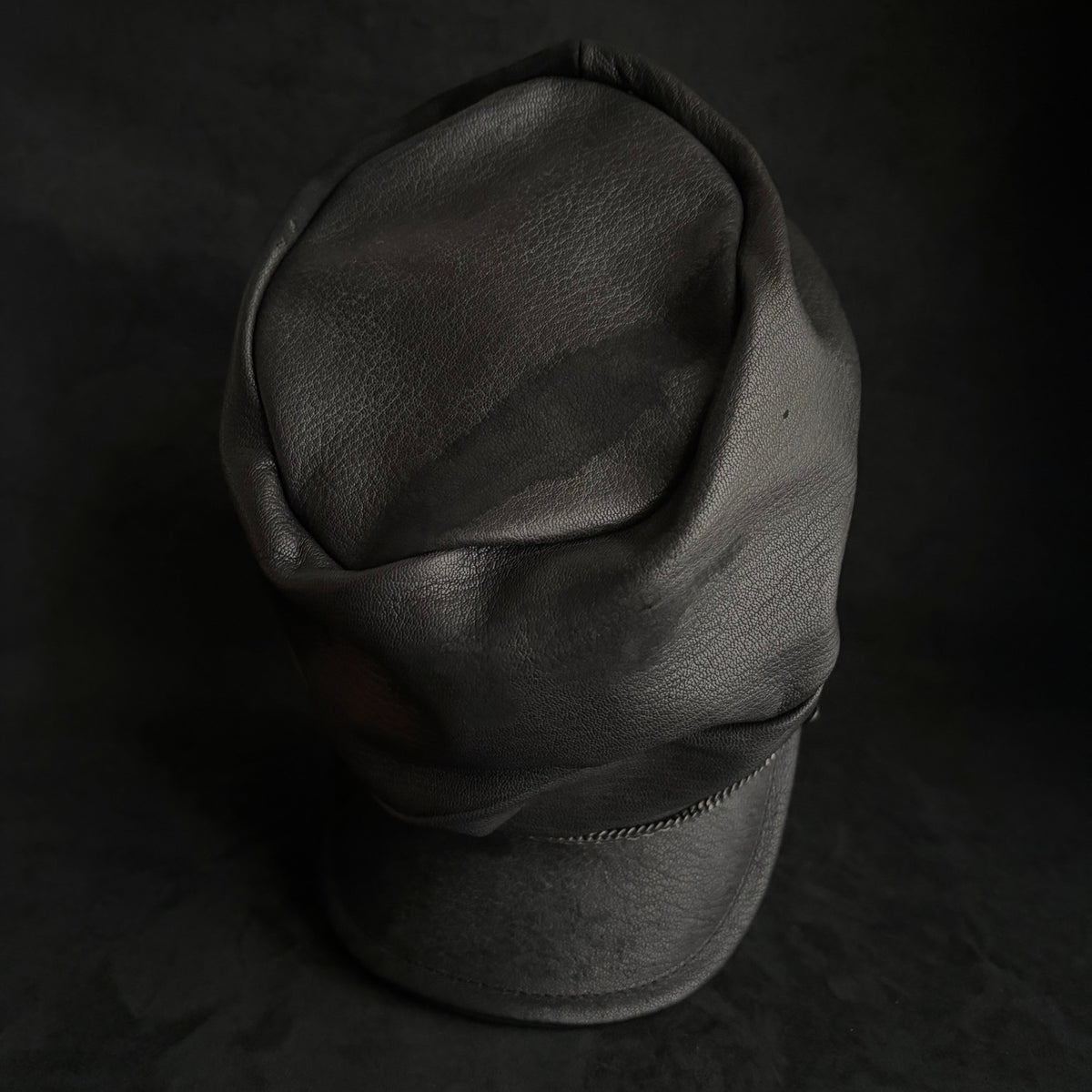 Grit black leather turn cap