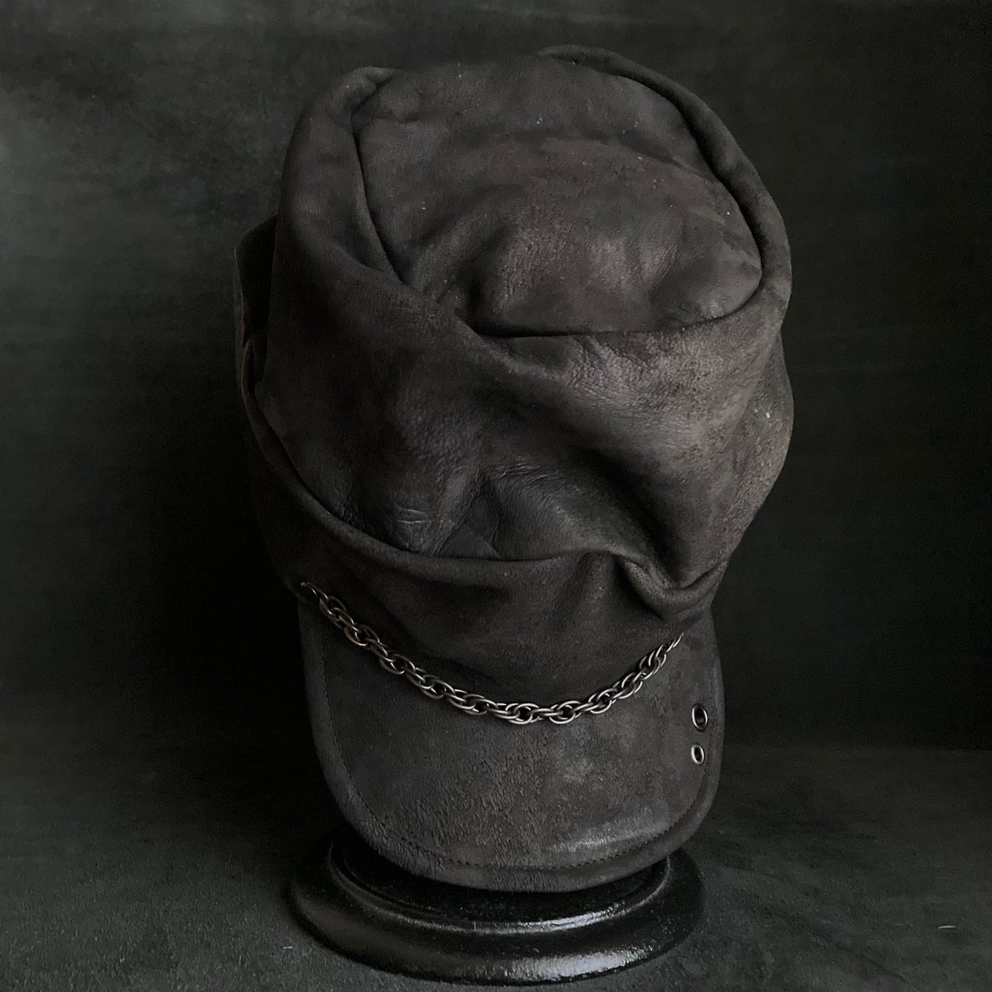 Rubbed black leather chain turn cap