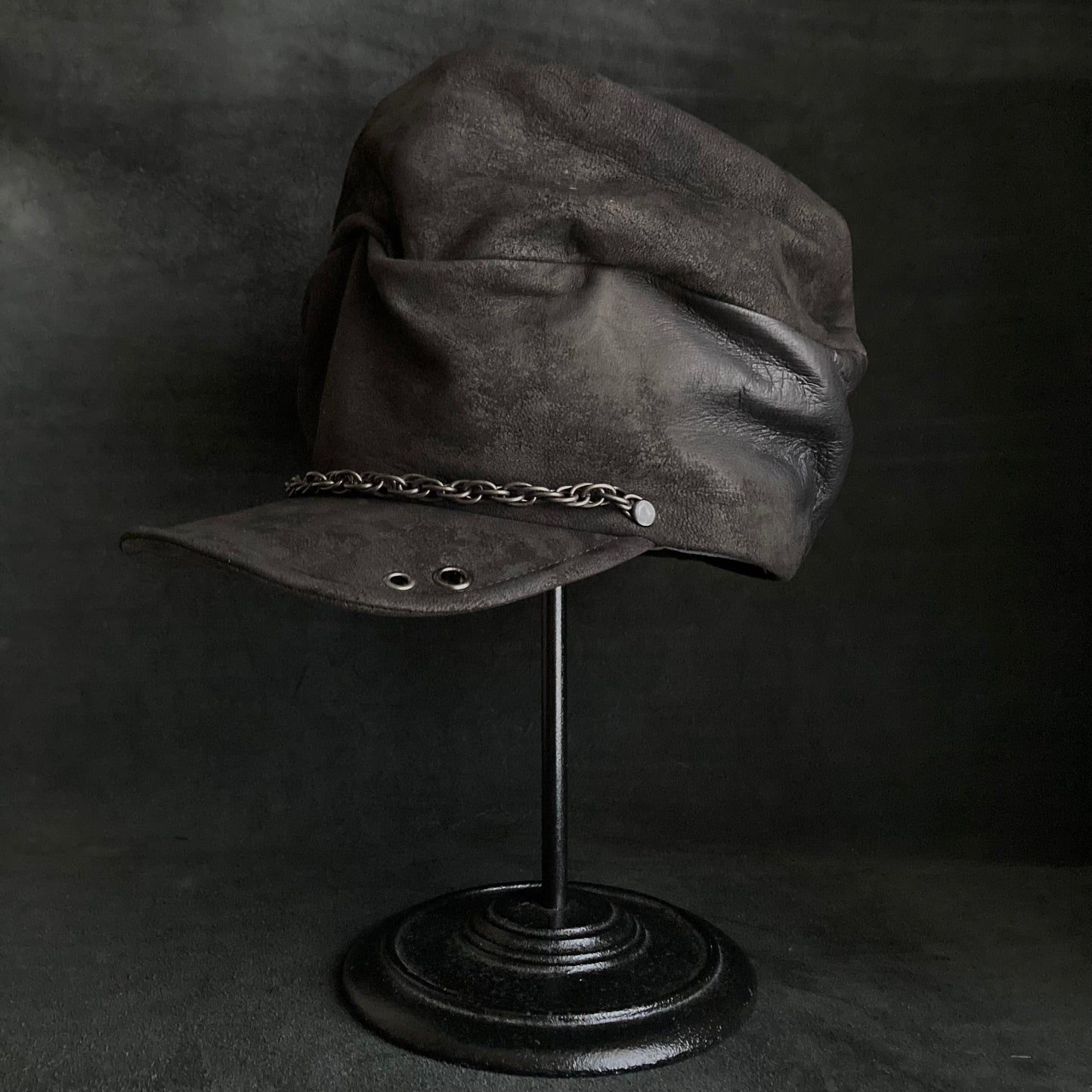 Rubbed black leather chain turn cap