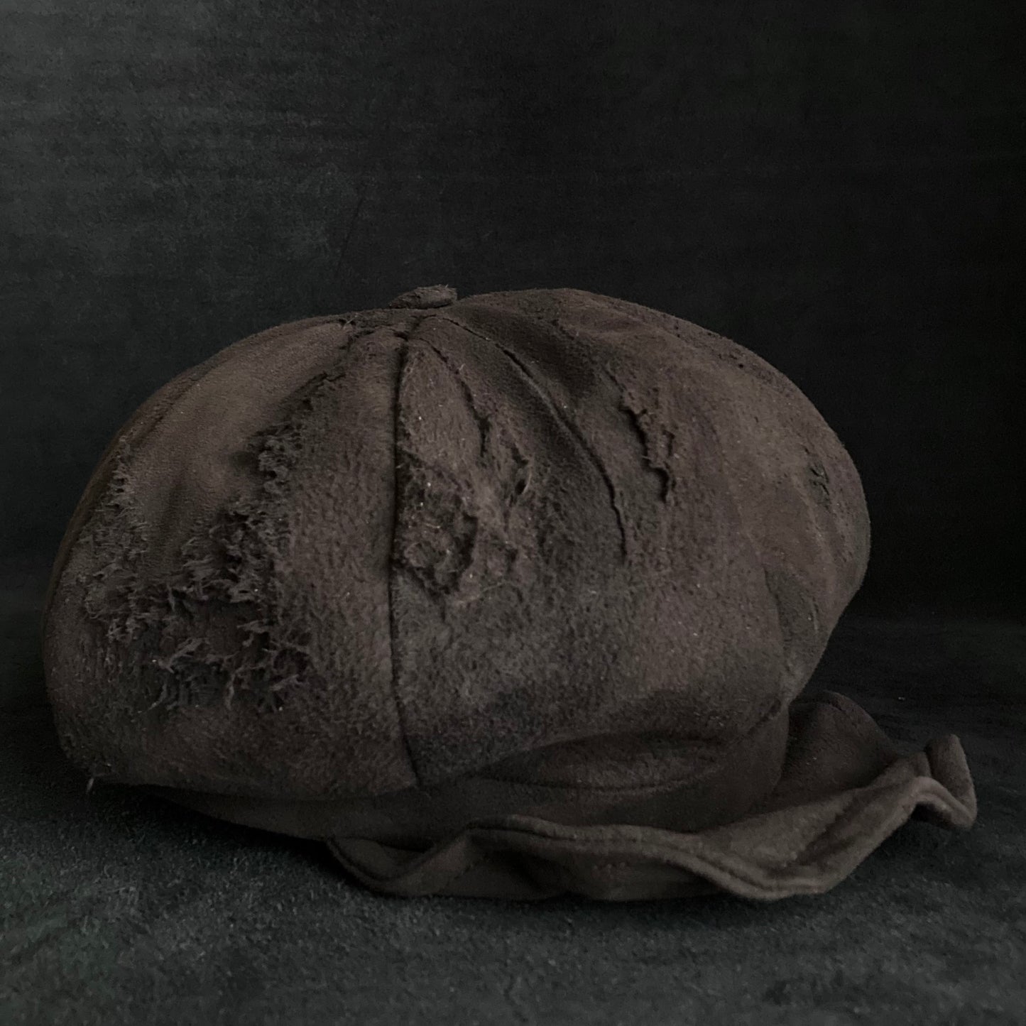 Worn out dark brown leather casquette