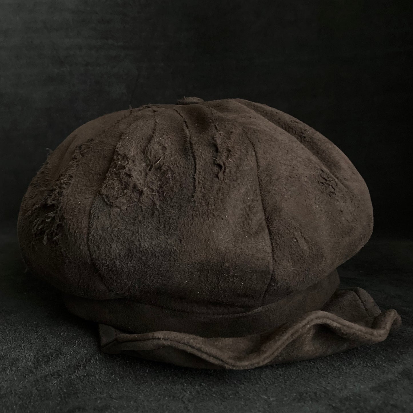 Worn out dark brown leather casquette