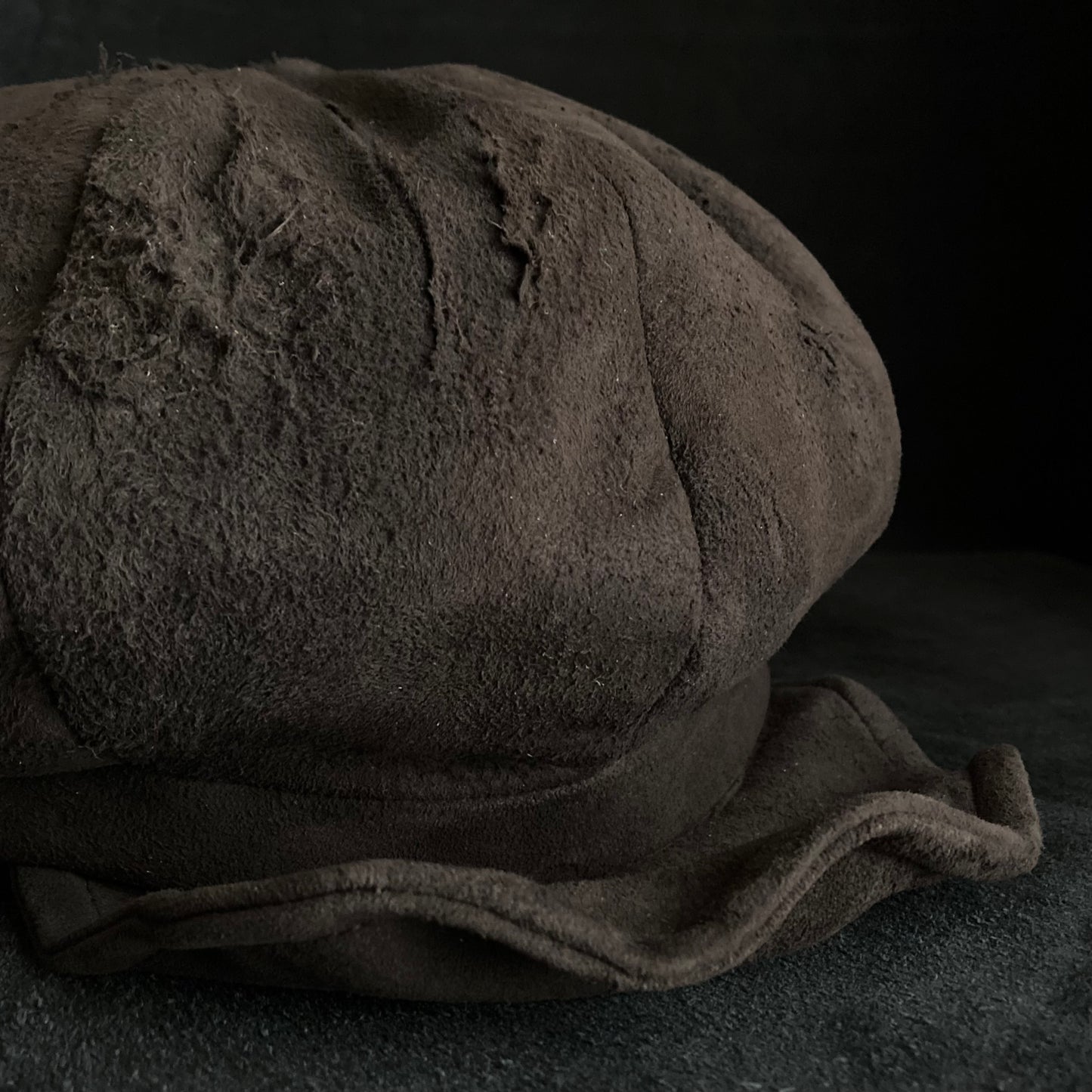 Worn out dark brown leather casquette