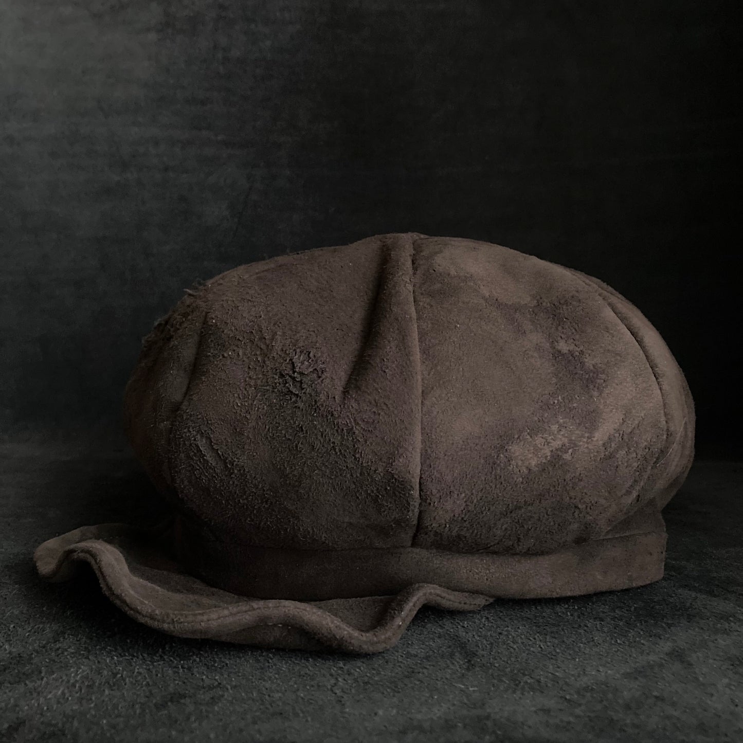 Worn out dark brown leather casquette