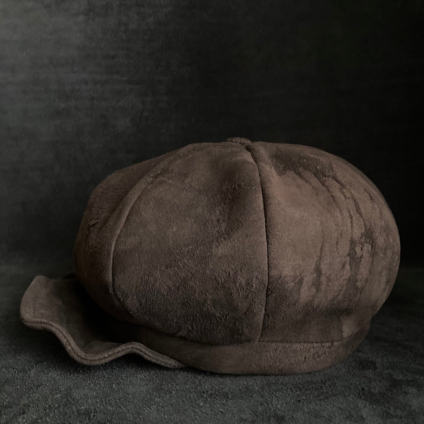 Worn out dark brown leather casquette