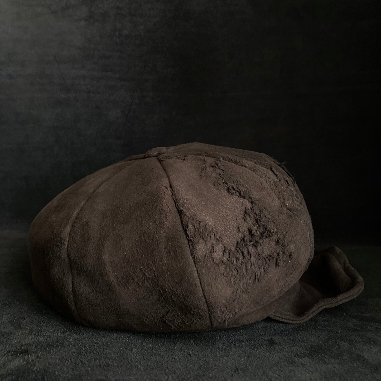Worn out dark brown leather casquette