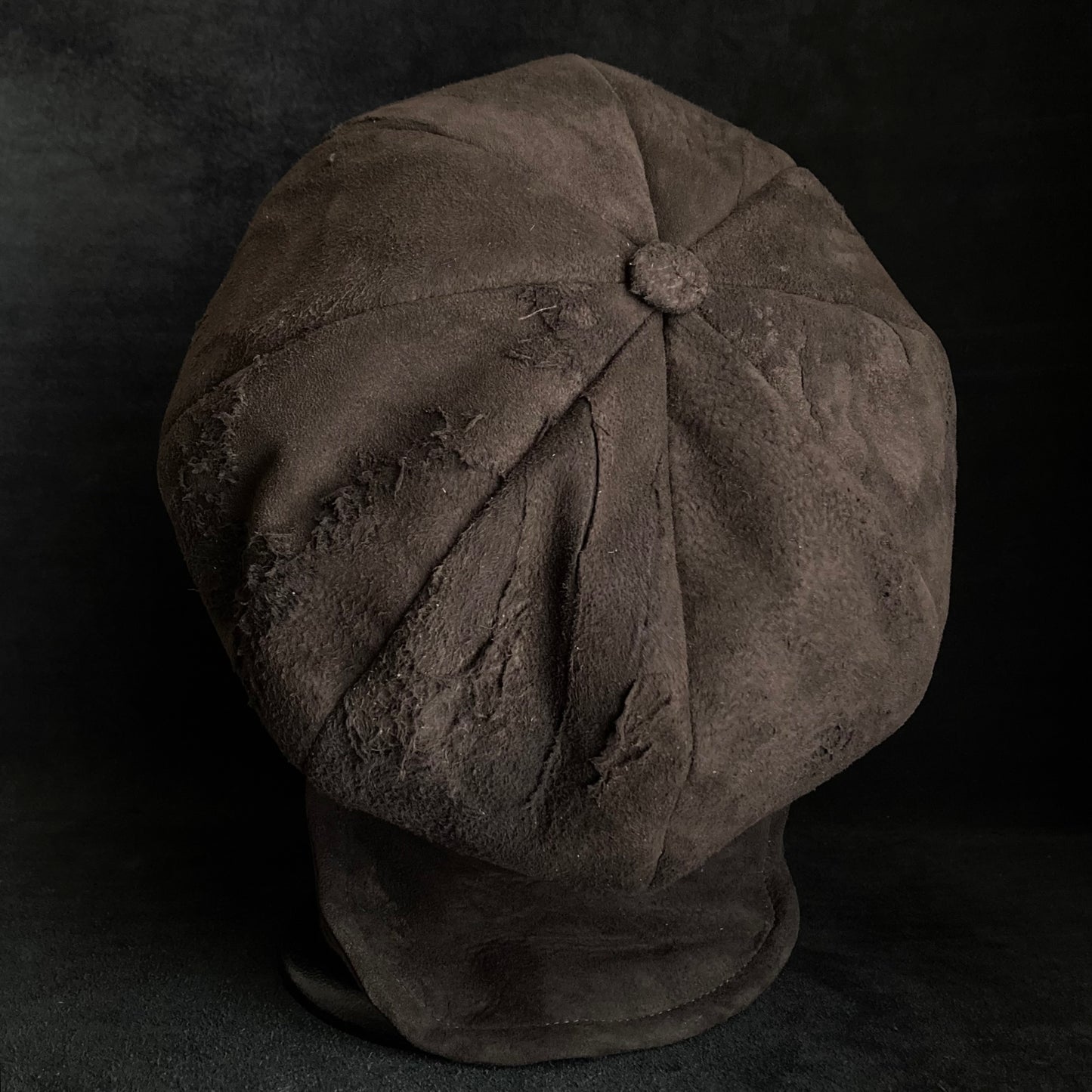 Worn out dark brown leather casquette