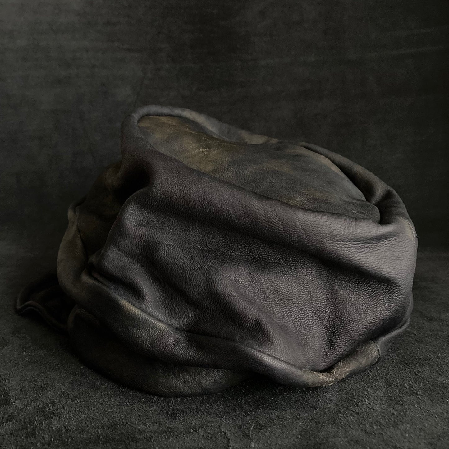 Old black leather turn cap