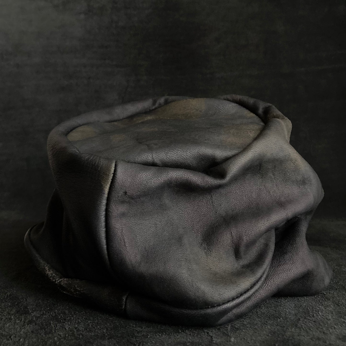 Old black leather turn cap