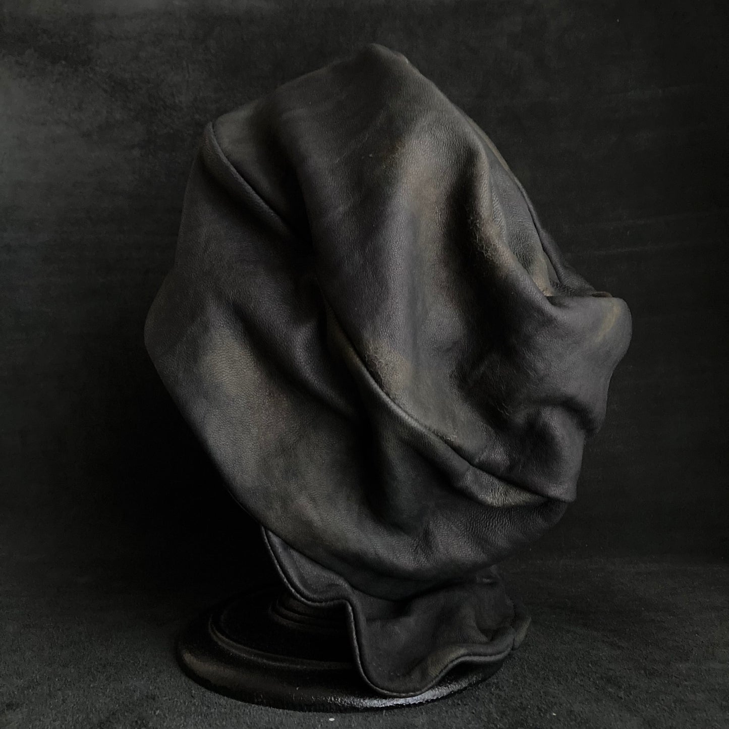 Old black leather turn cap