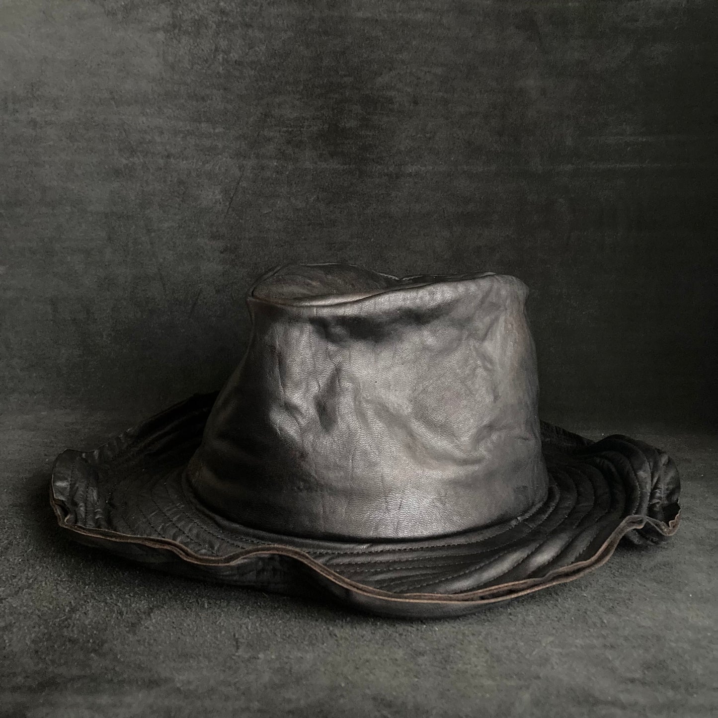 Cracked black leather fedora hat