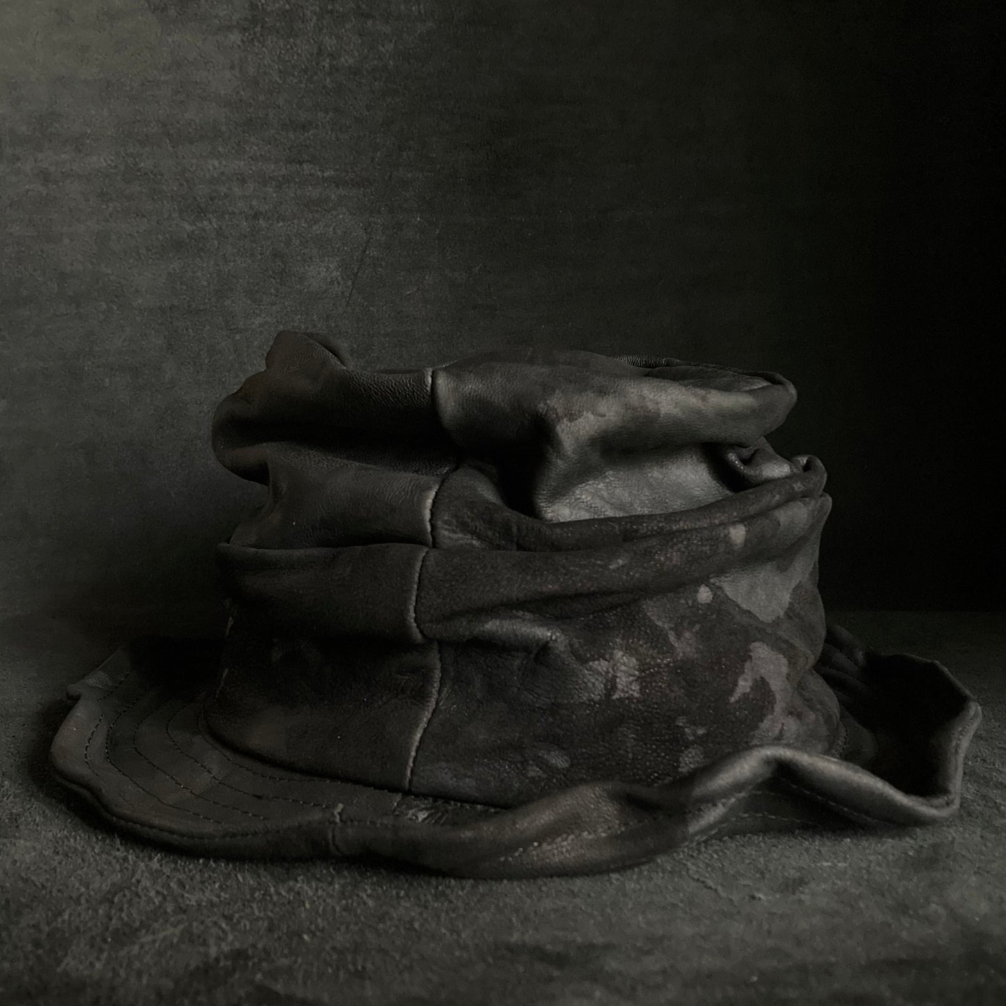 Bleached black leather turn bucket hat