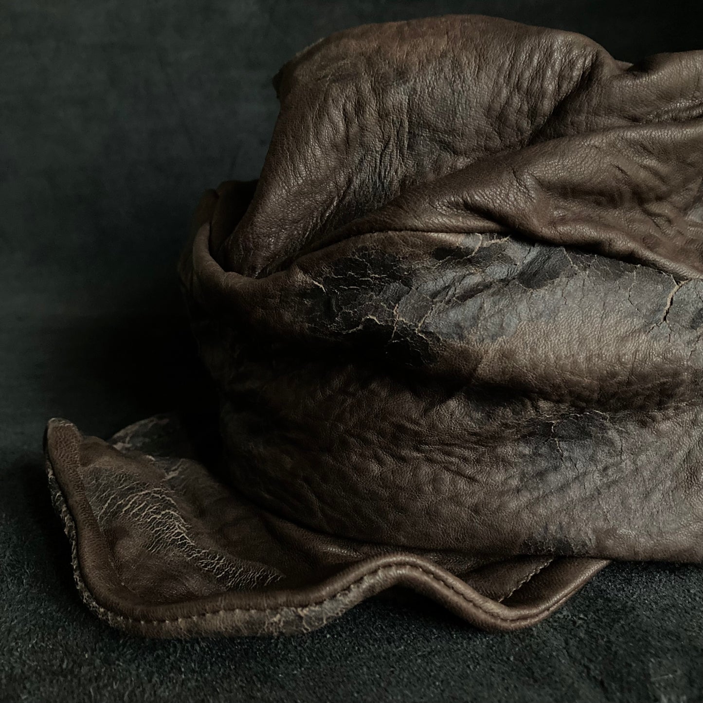 Cracked dark brown leather turn cap