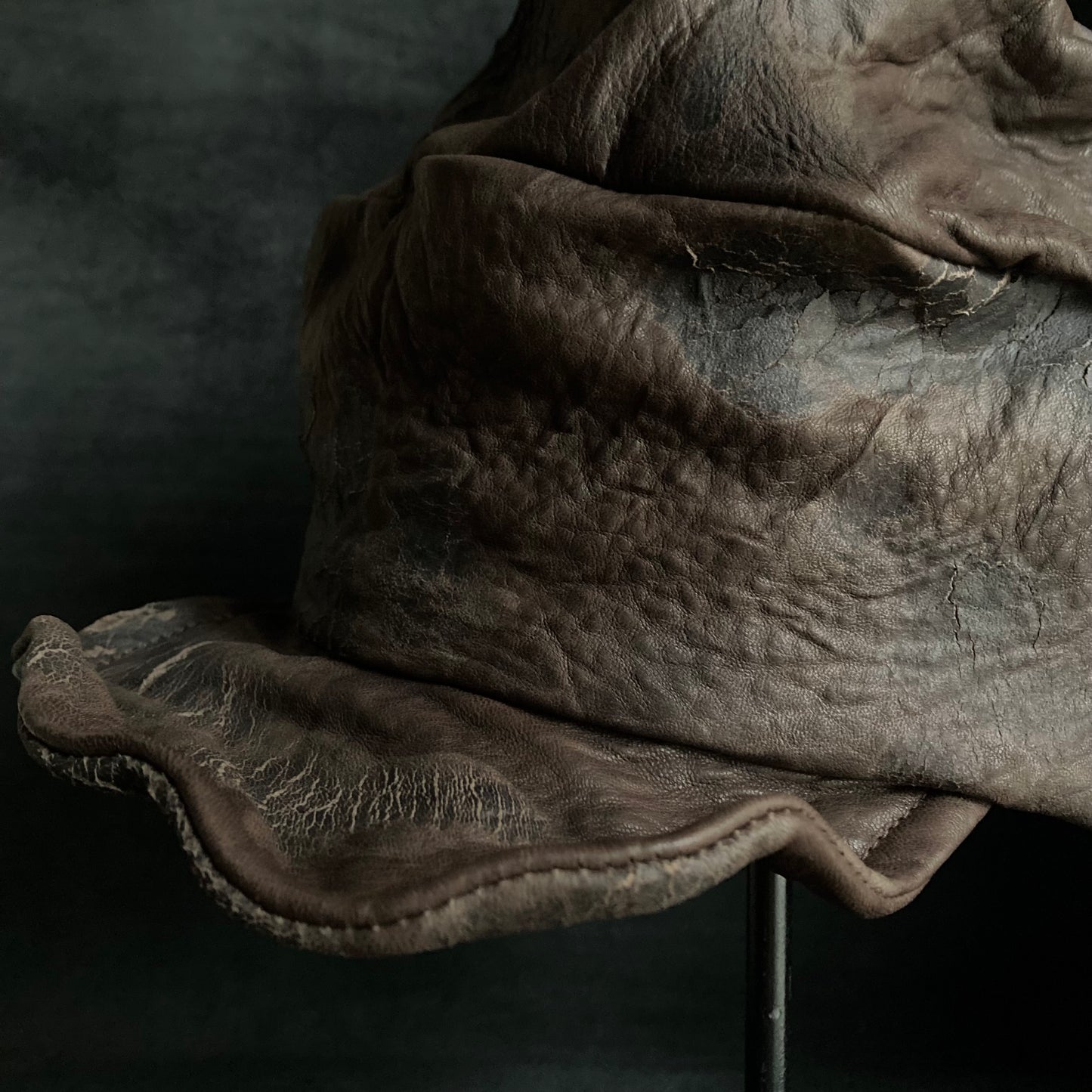 Cracked dark brown leather turn cap