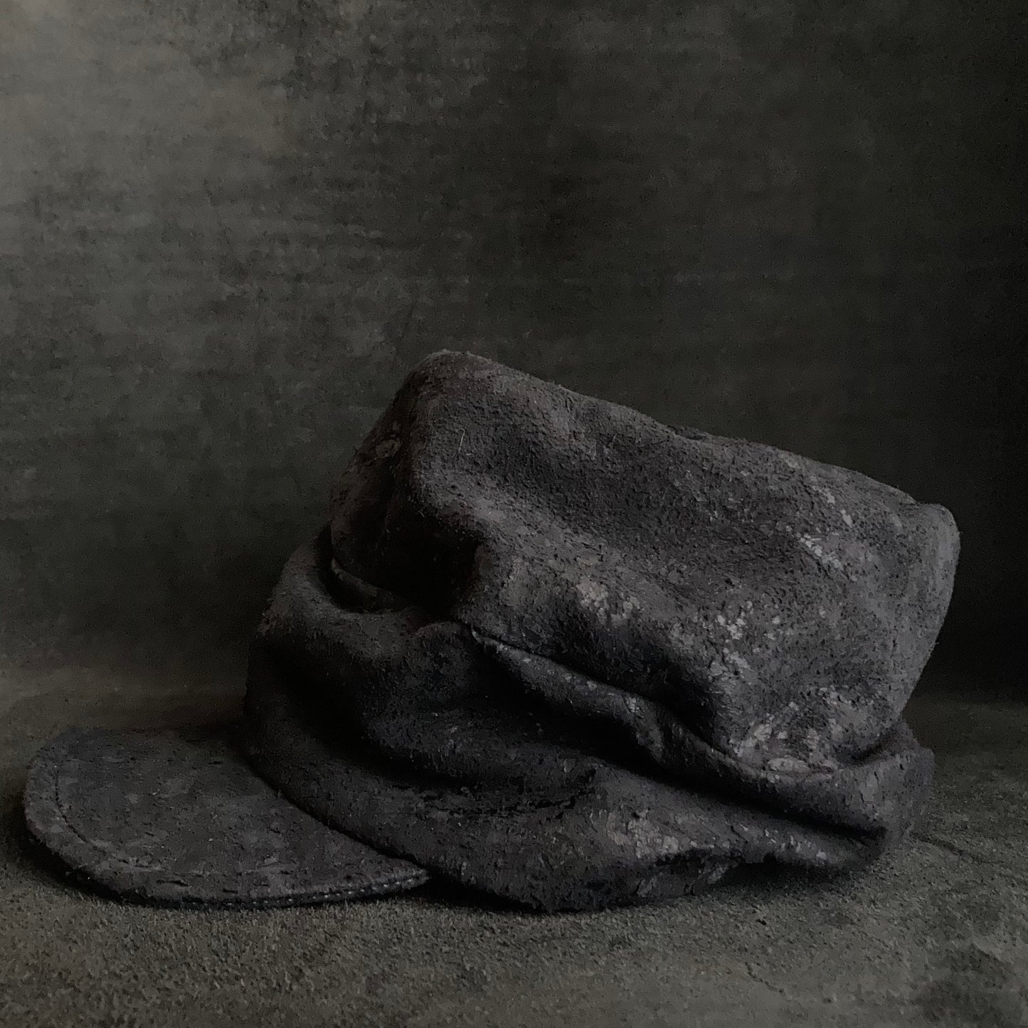 Scrape black leather turn cap