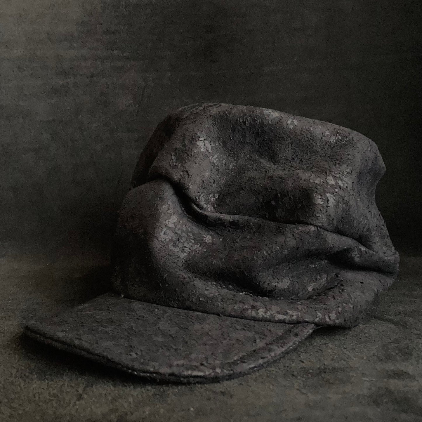 Scrape black leather turn cap