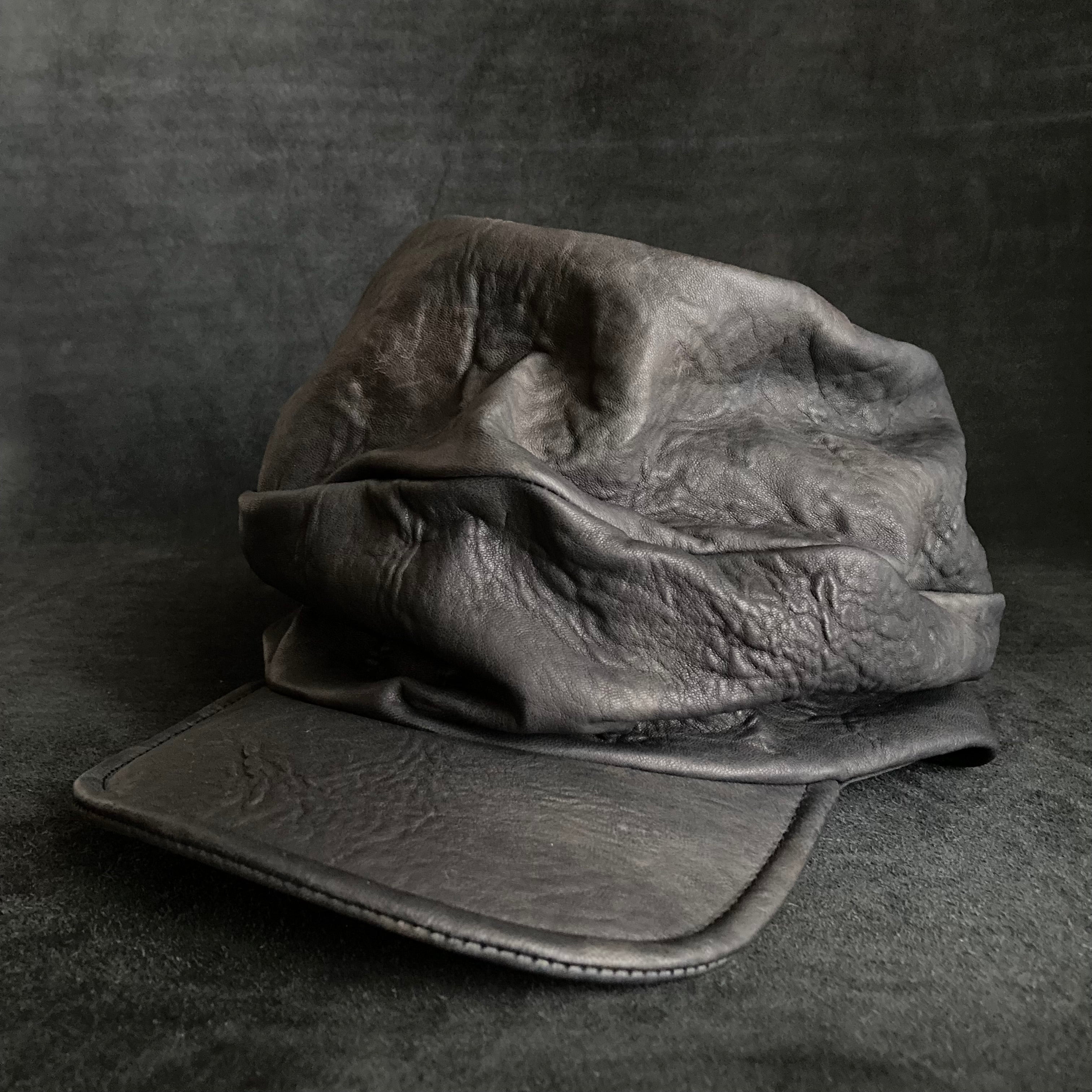 Wiggly black leather turn cap – triangles hat