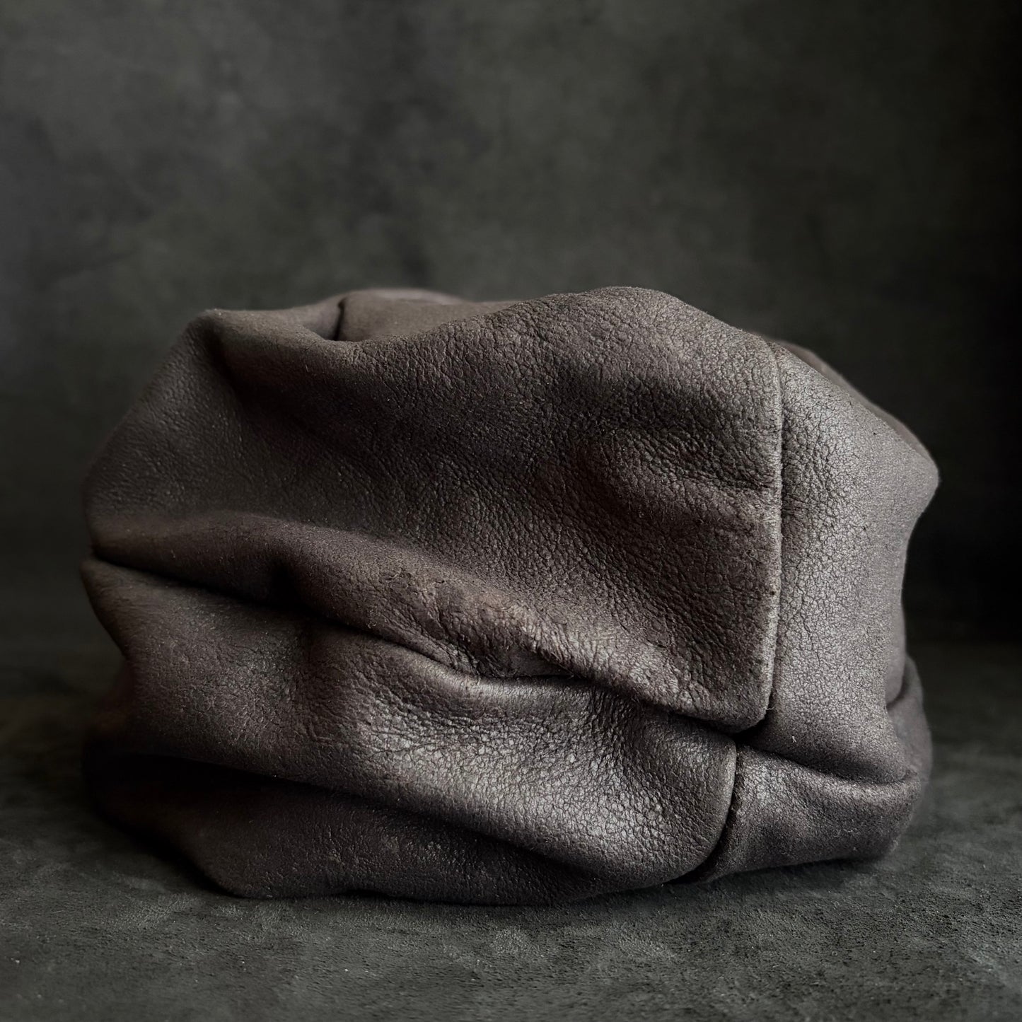 Graphite black leather turn cap