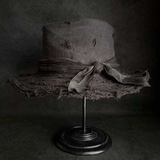 Black linen damage around fedora hat