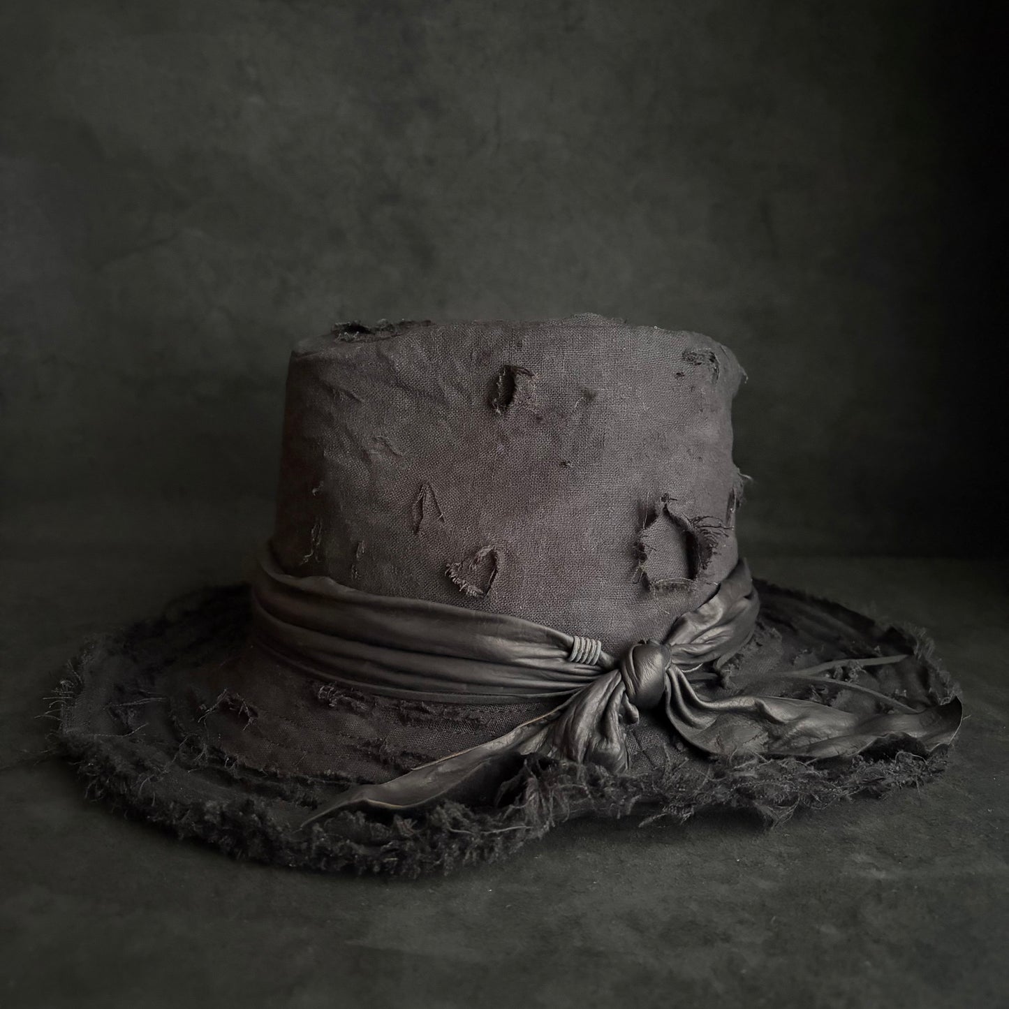 Black linen damage around fedora hat