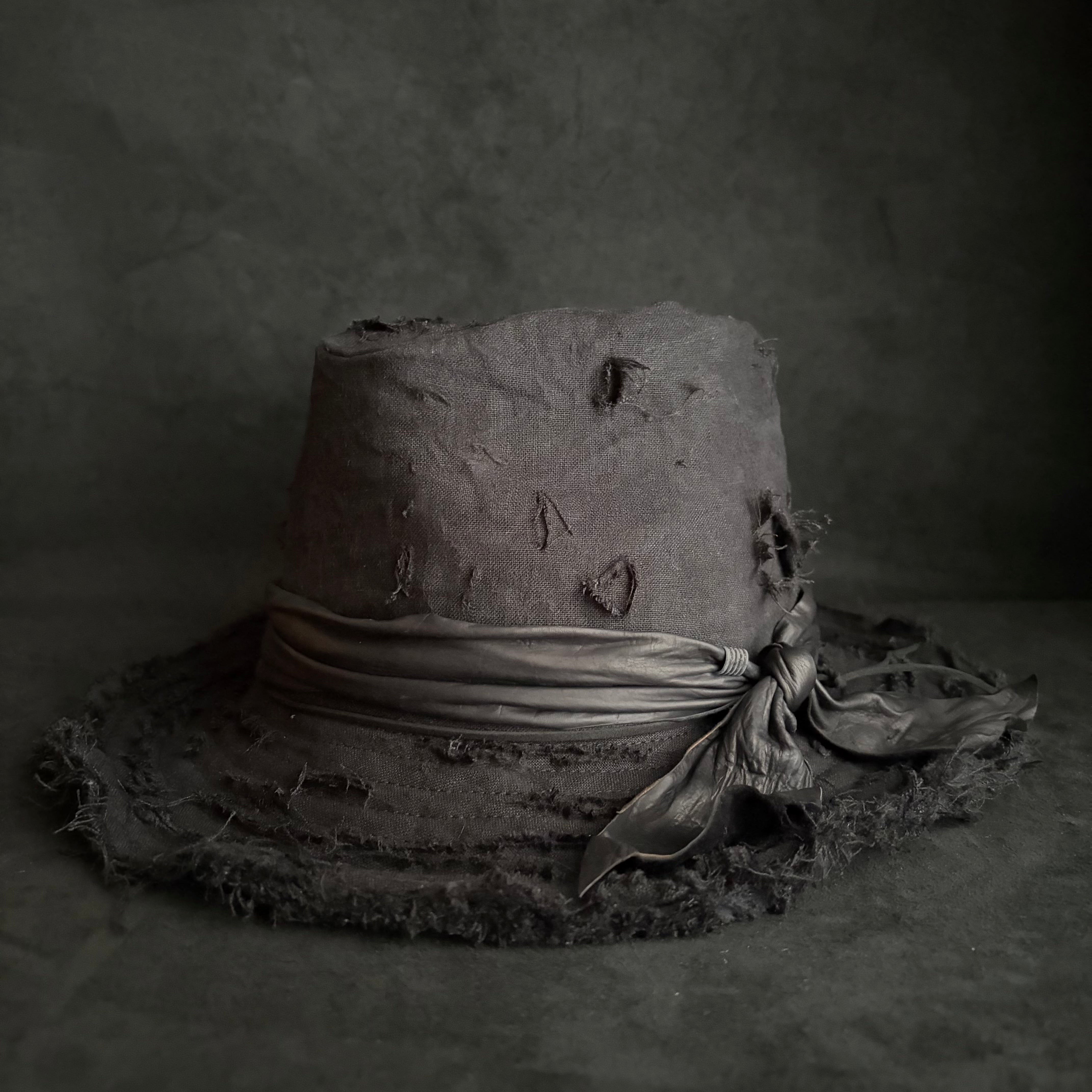 Black linen damage around fedora hat – triangles hat
