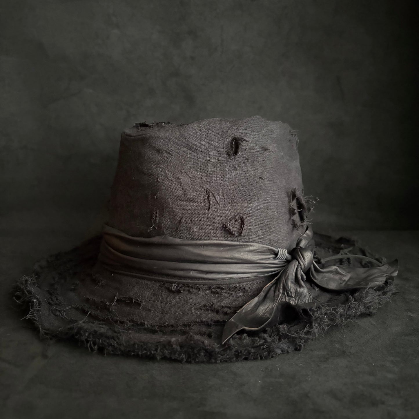 Black linen damage around fedora hat