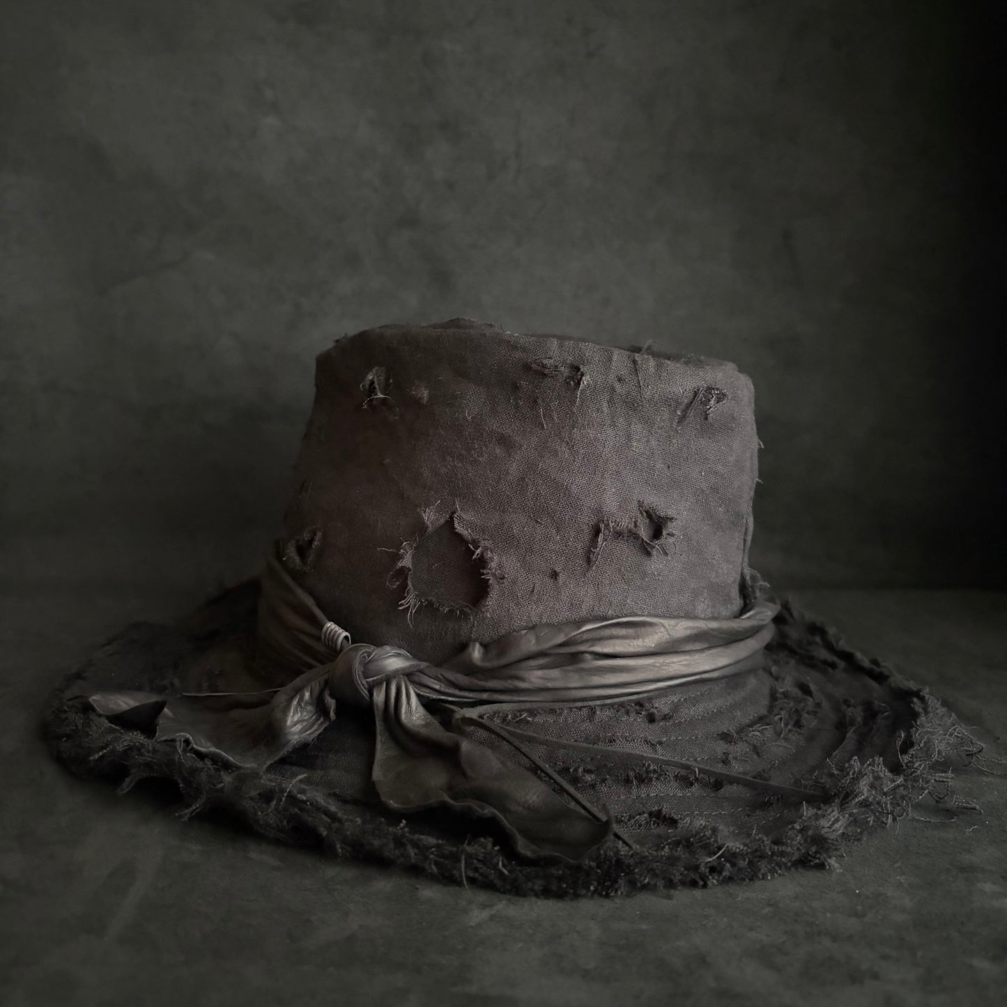 Black linen damage around fedora hat
