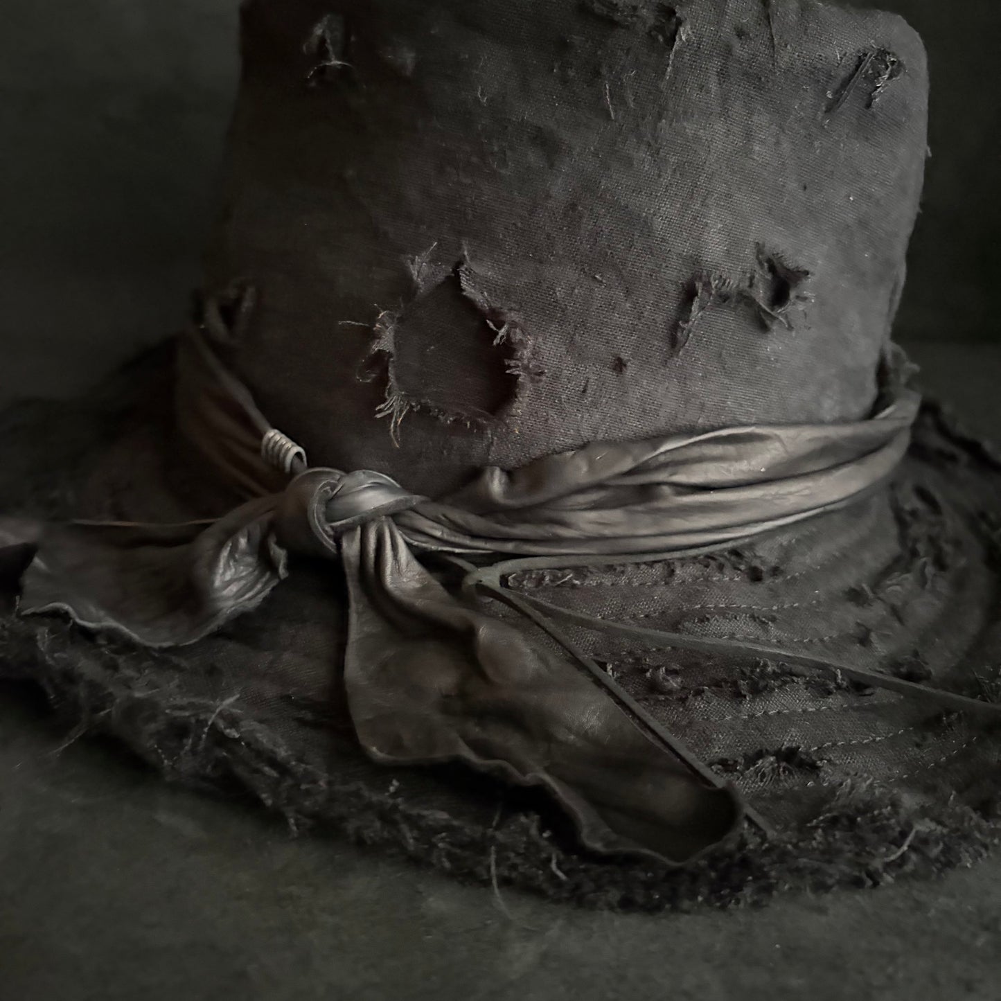 Black linen damage around fedora hat