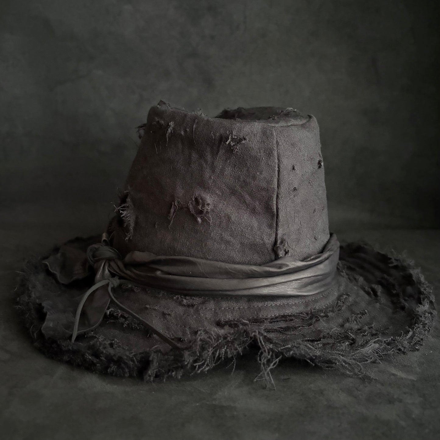 Black linen damage around fedora hat