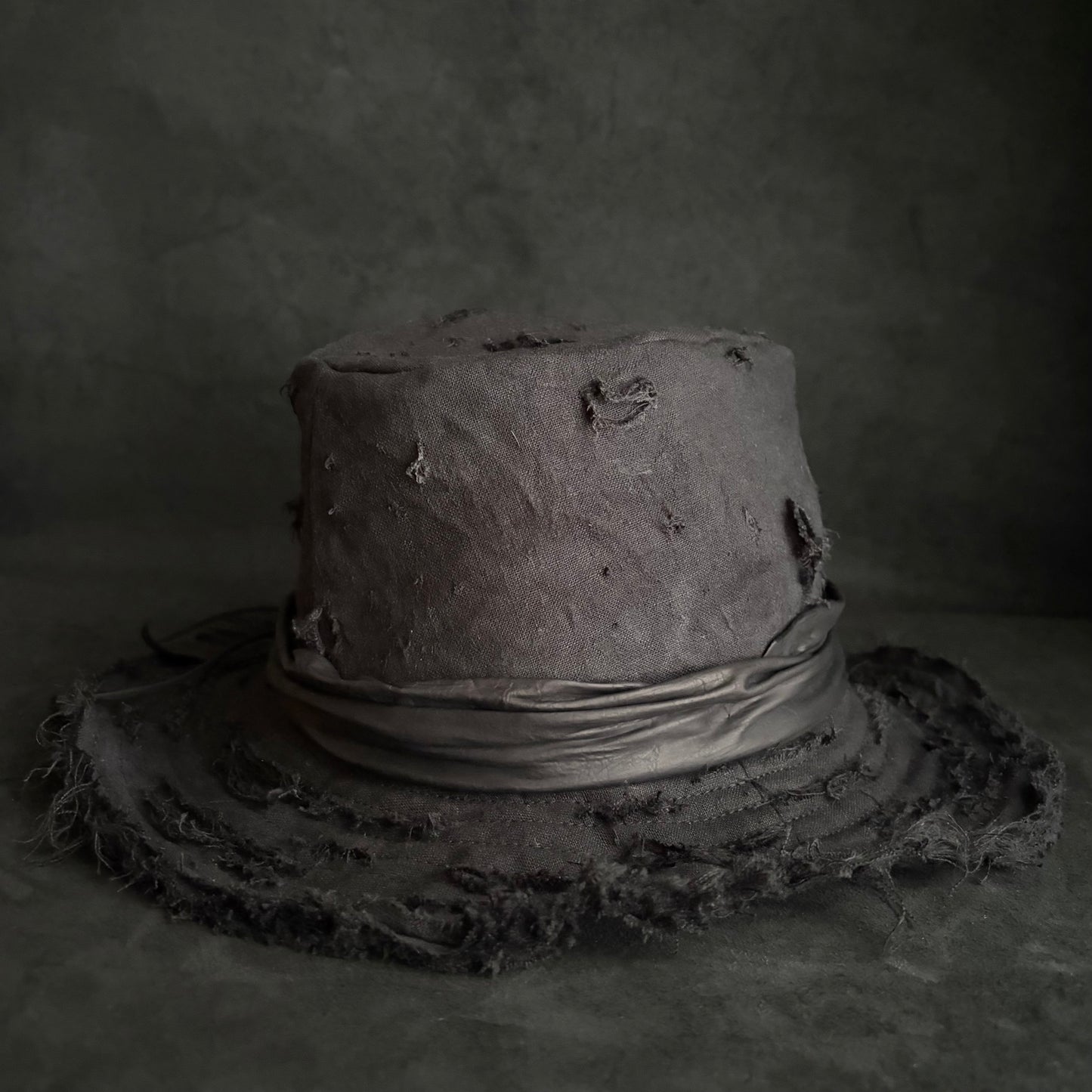 Black linen damage around fedora hat