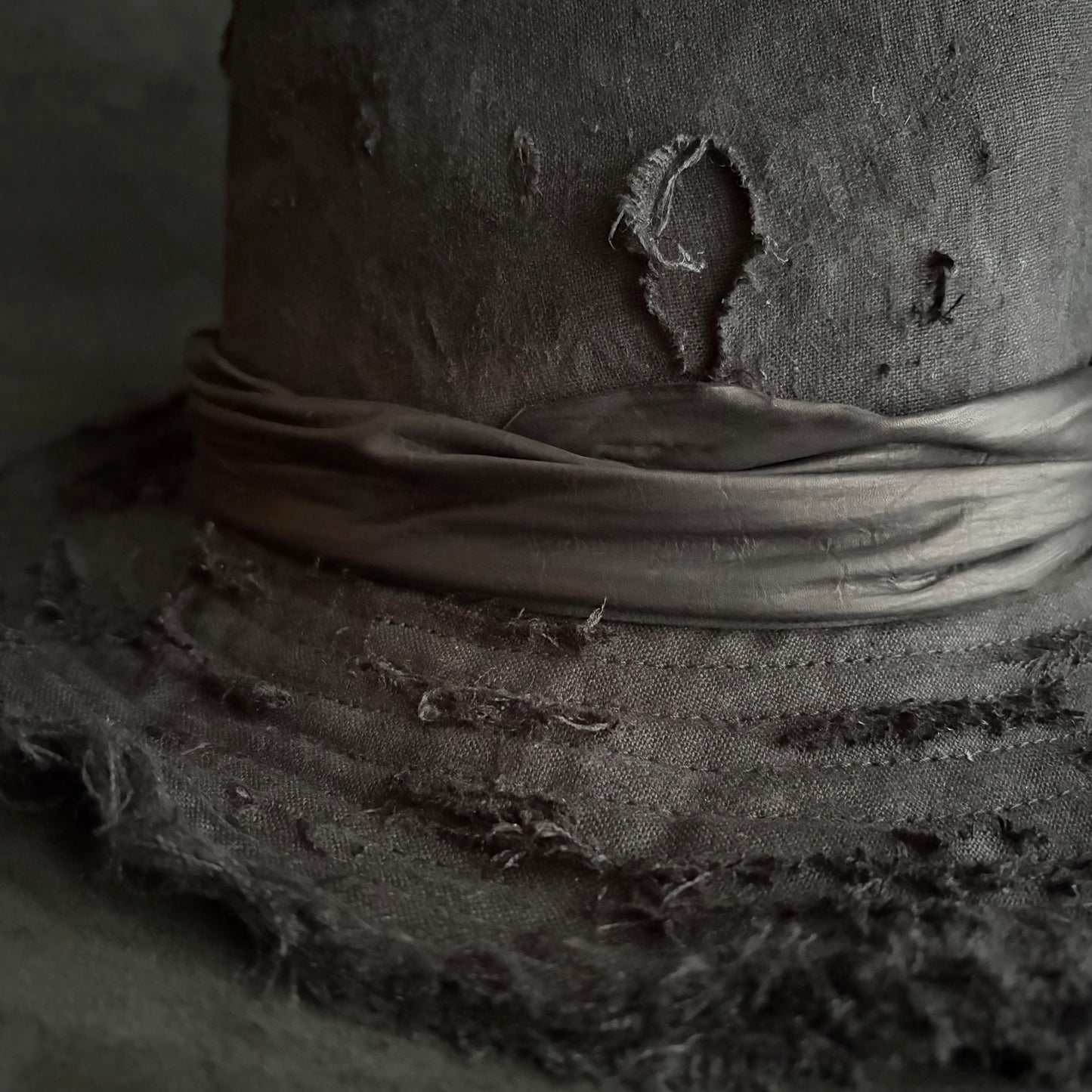 Black linen damage around fedora hat