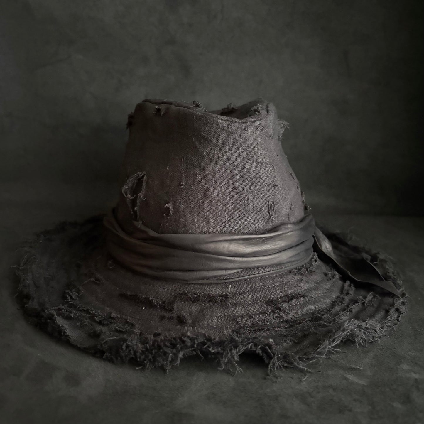 Black linen damage around fedora hat