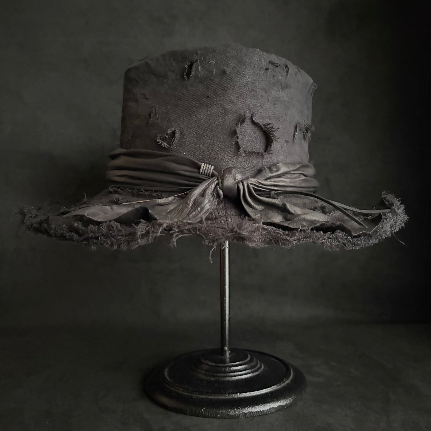 Black linen damage around fedora hat