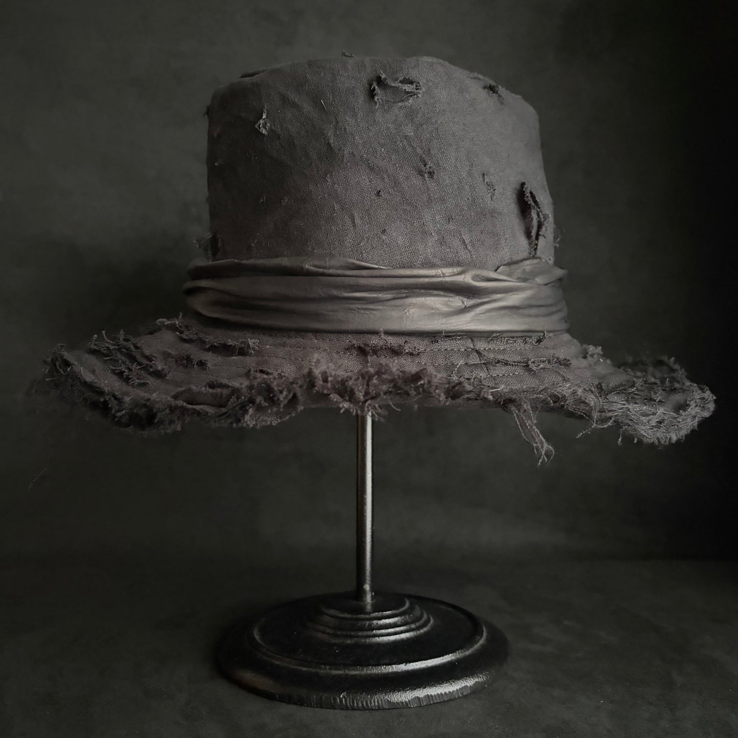 Black linen damage around fedora hat