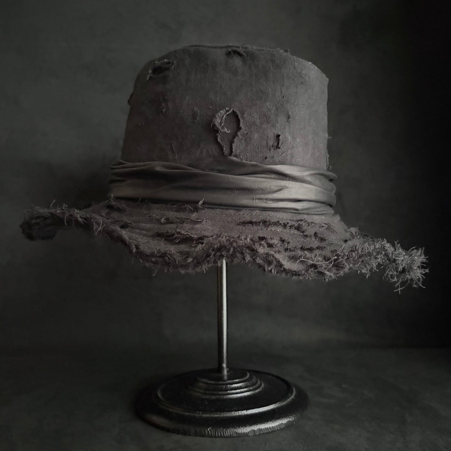 Black linen damage around fedora hat
